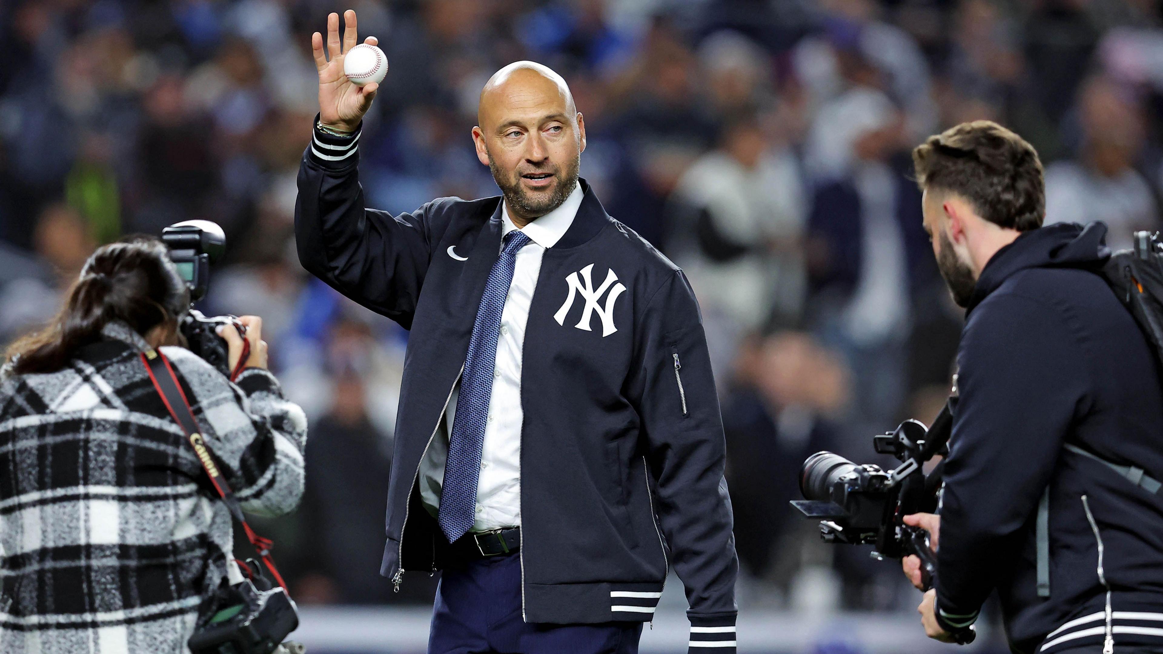 New York Yankees legend Derek Jeter waves to the crowd as he prepares to throw out the ceremonial first pitch