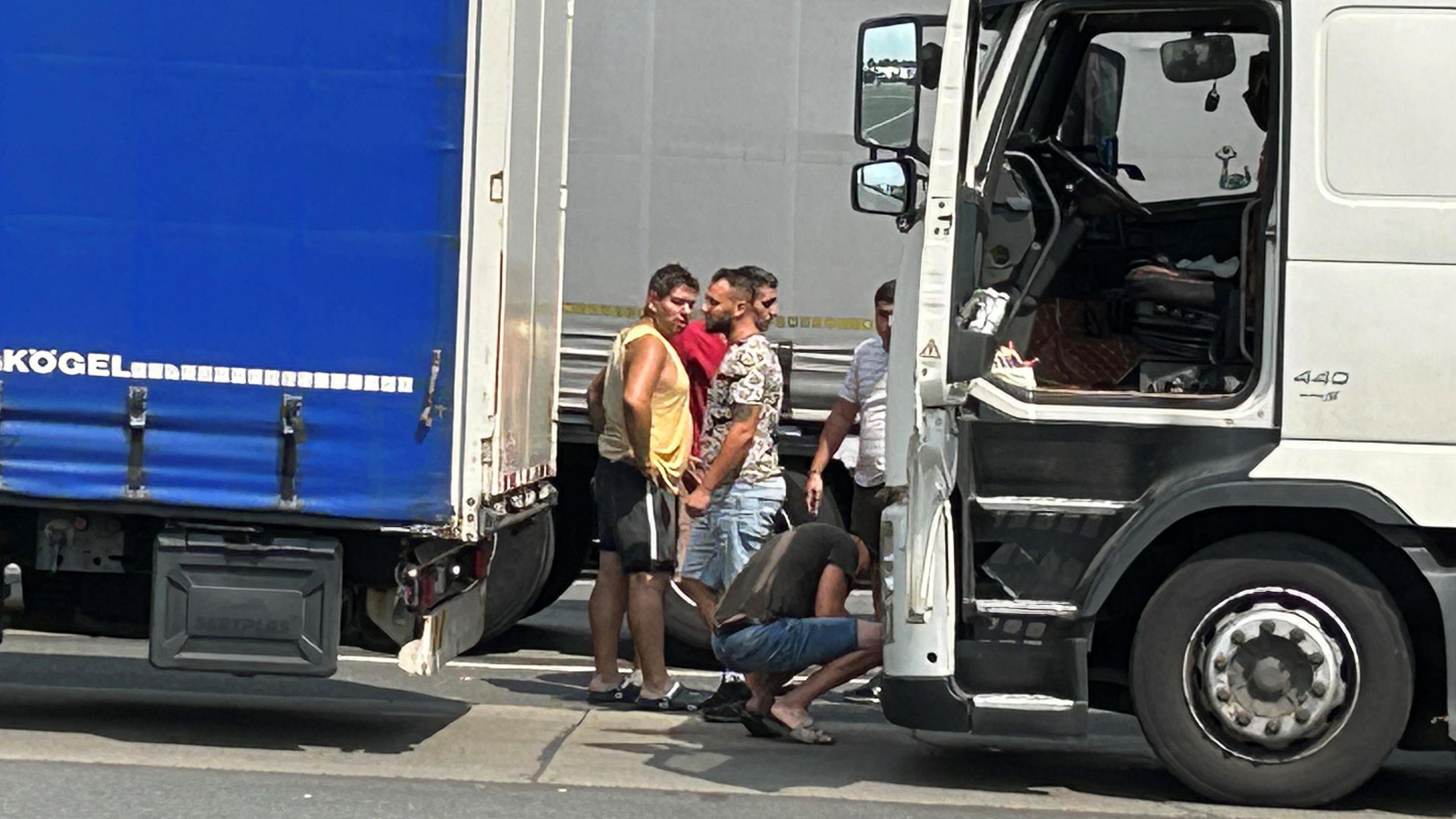 Lorry drivers wait at the border between Hungary and Romania during the summer