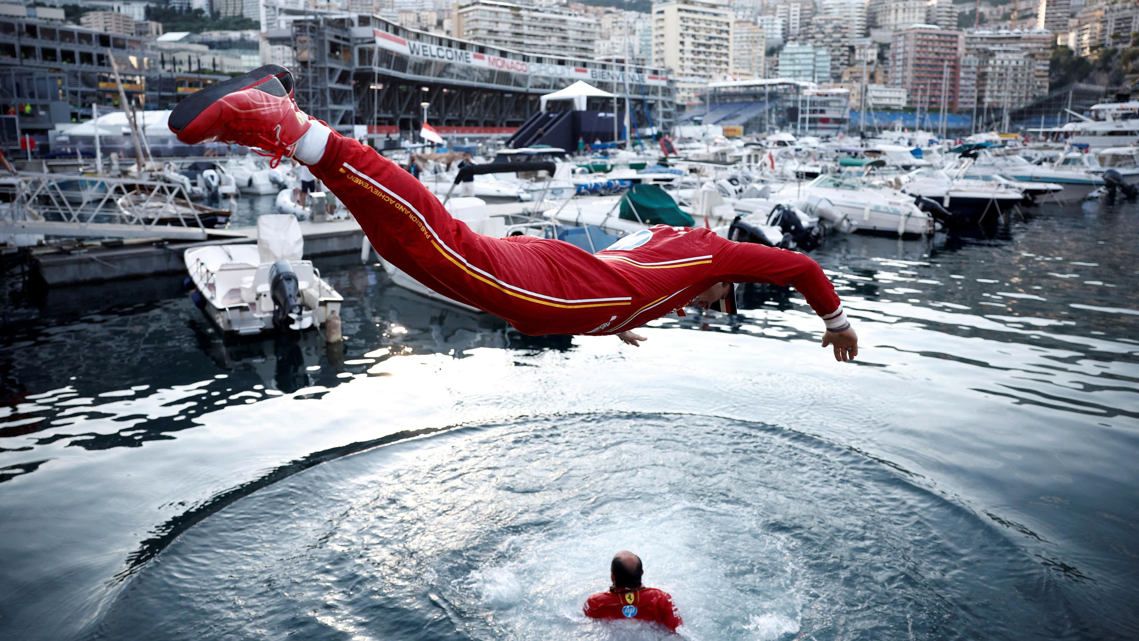 Ferrari's Charles Leclerc dives into the harbour in celebration after his victory in 2024
