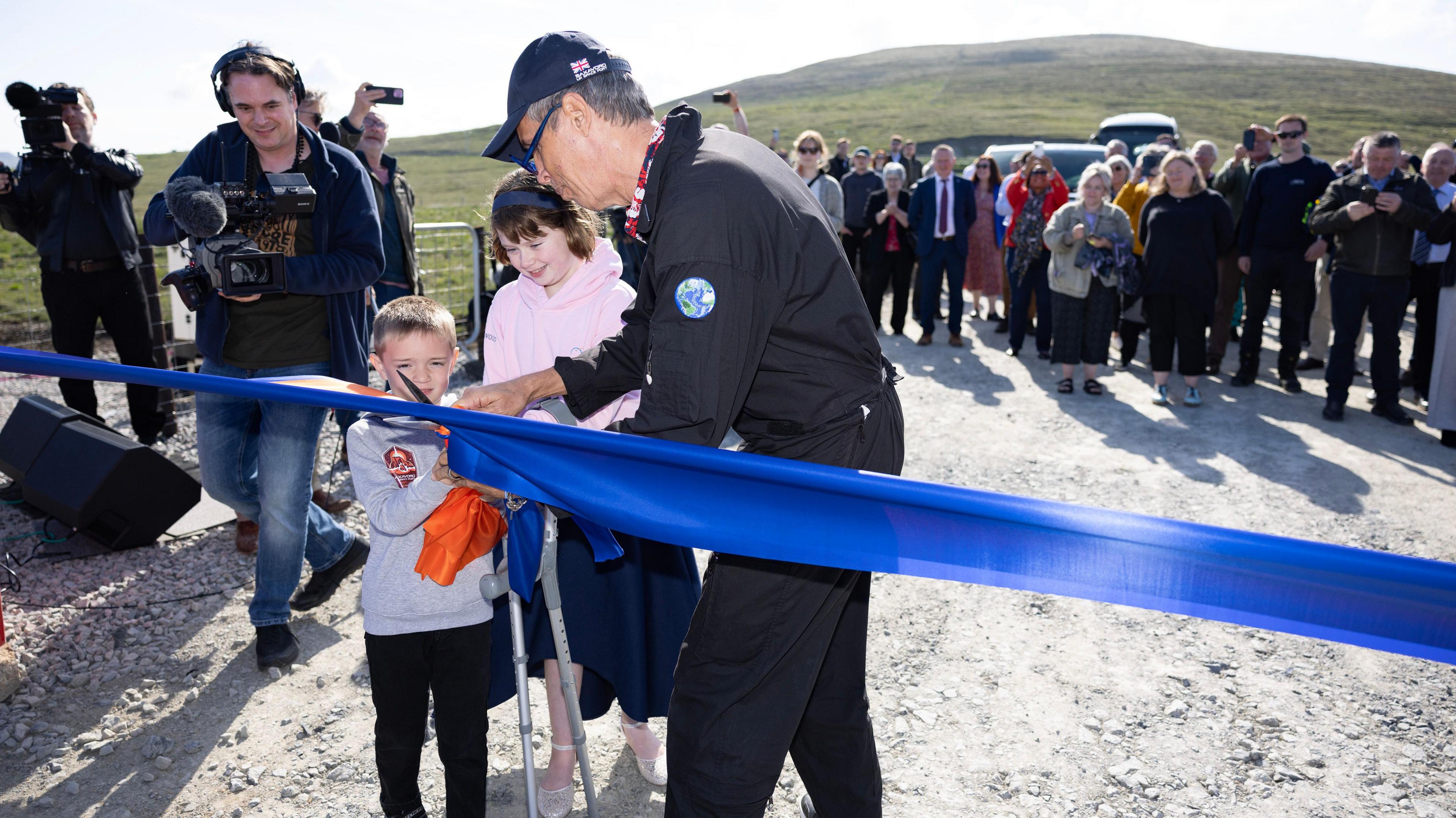 grace, harry and mike cutting the ribbon at the saxavord opening ceremony