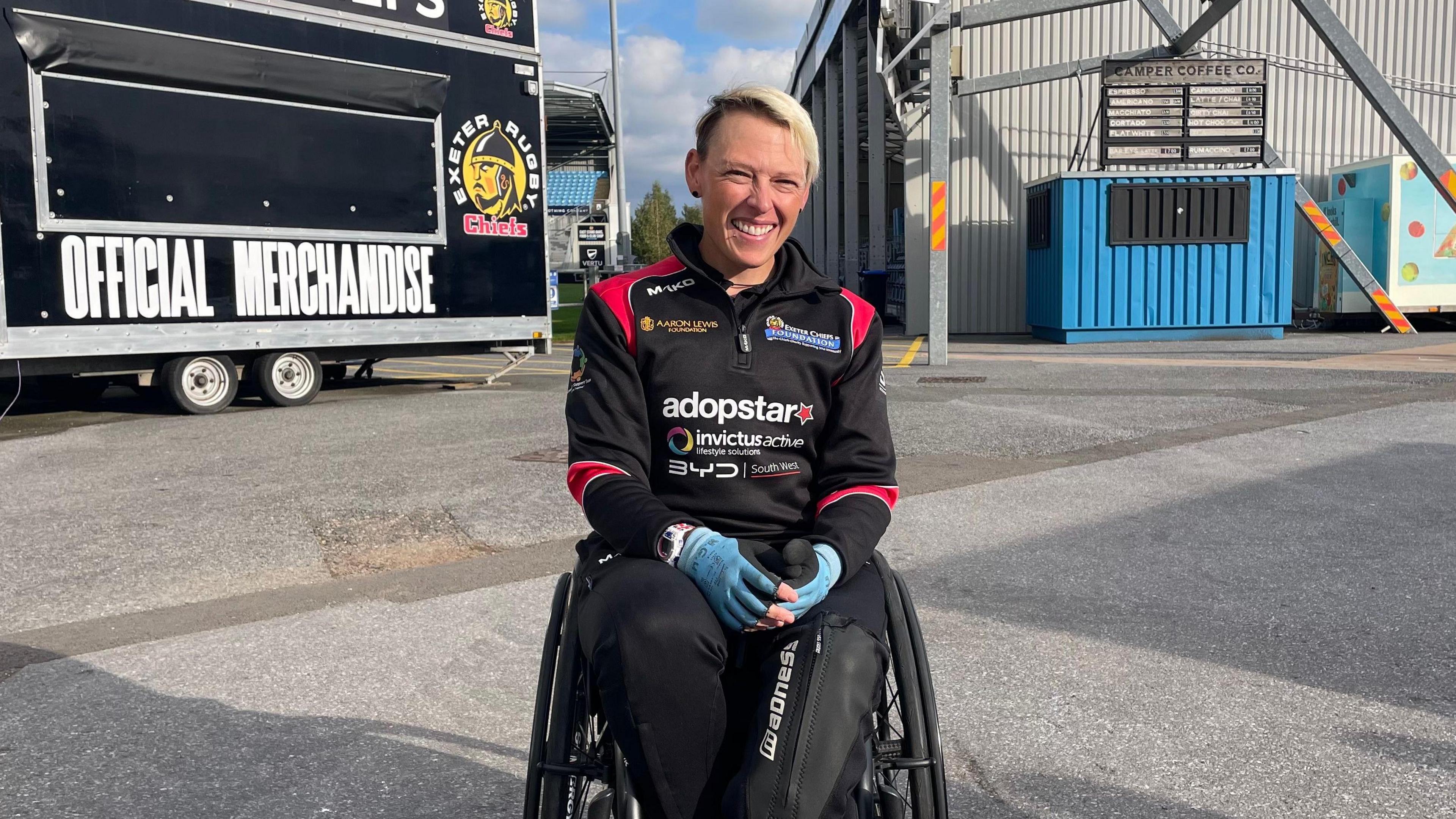 Lexi Chamber, sat in her wheelchair outside Exeter Chief's stadium, Sandy Park