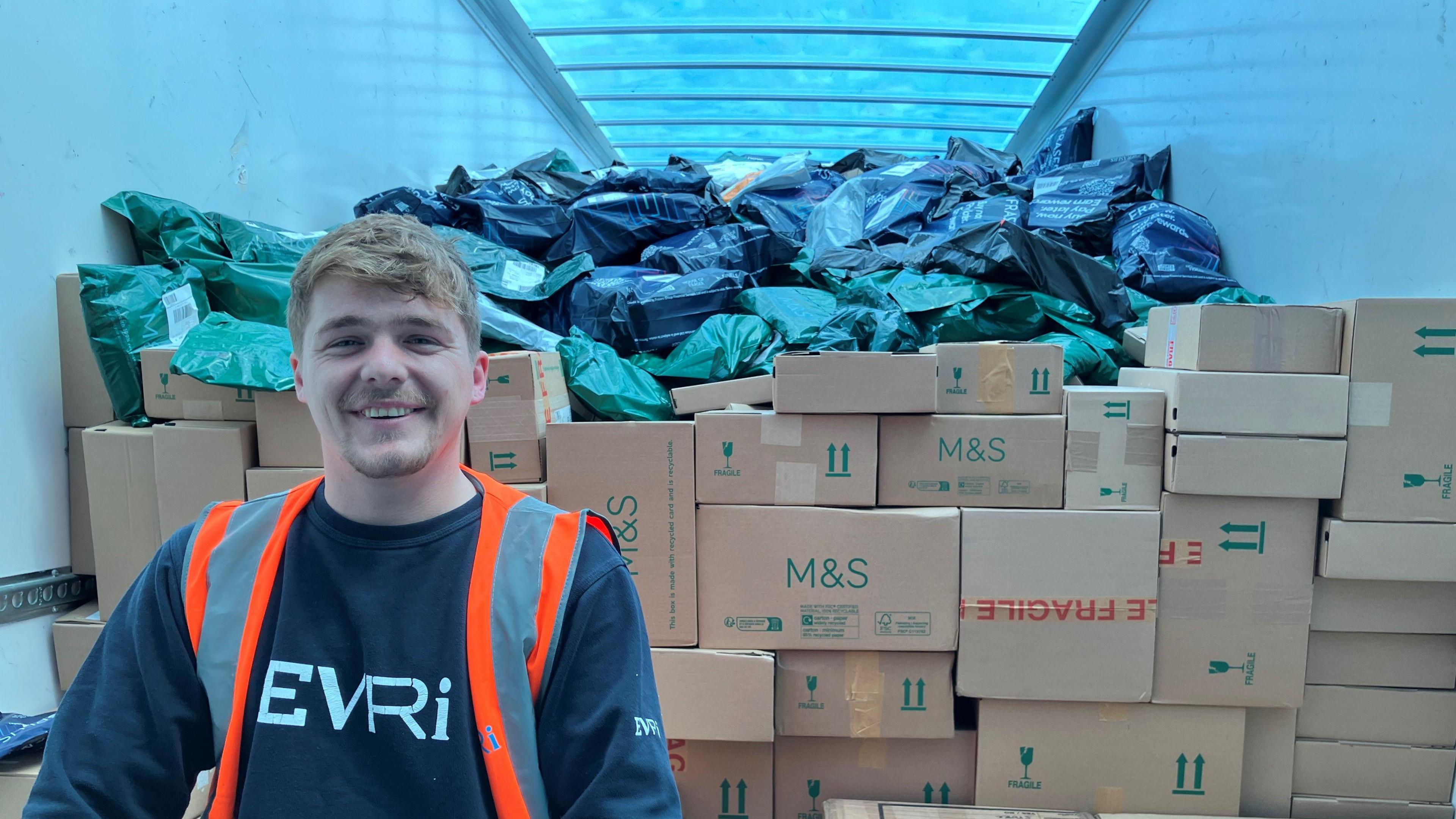 Maxwell Henderson packing parcels back on to a lorry, ready for them to be delivered across the country