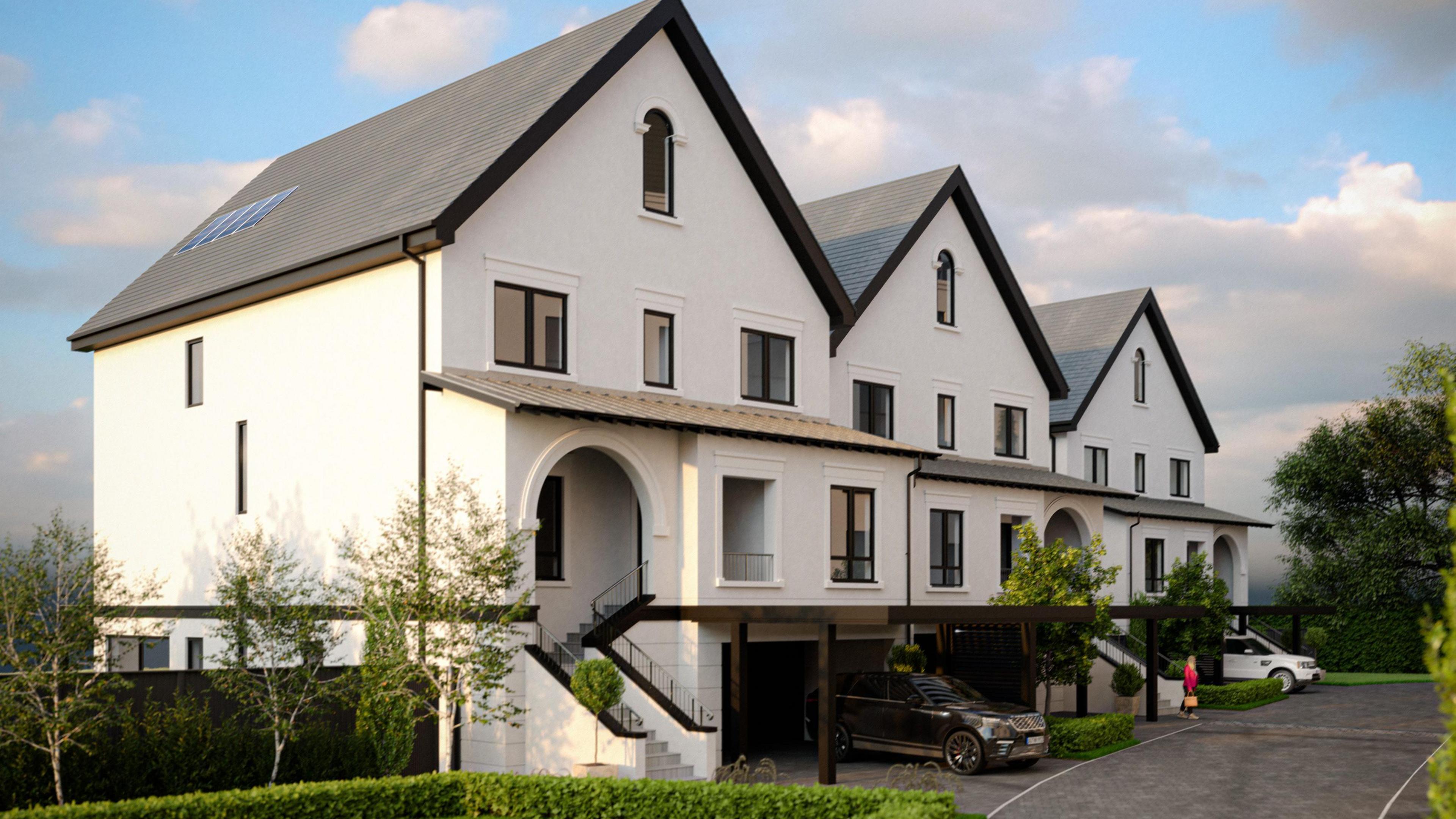 A corner view of white, modern large houses attached to each other, with cars beneath them and black window frames and fascias, and archways at each entrance.