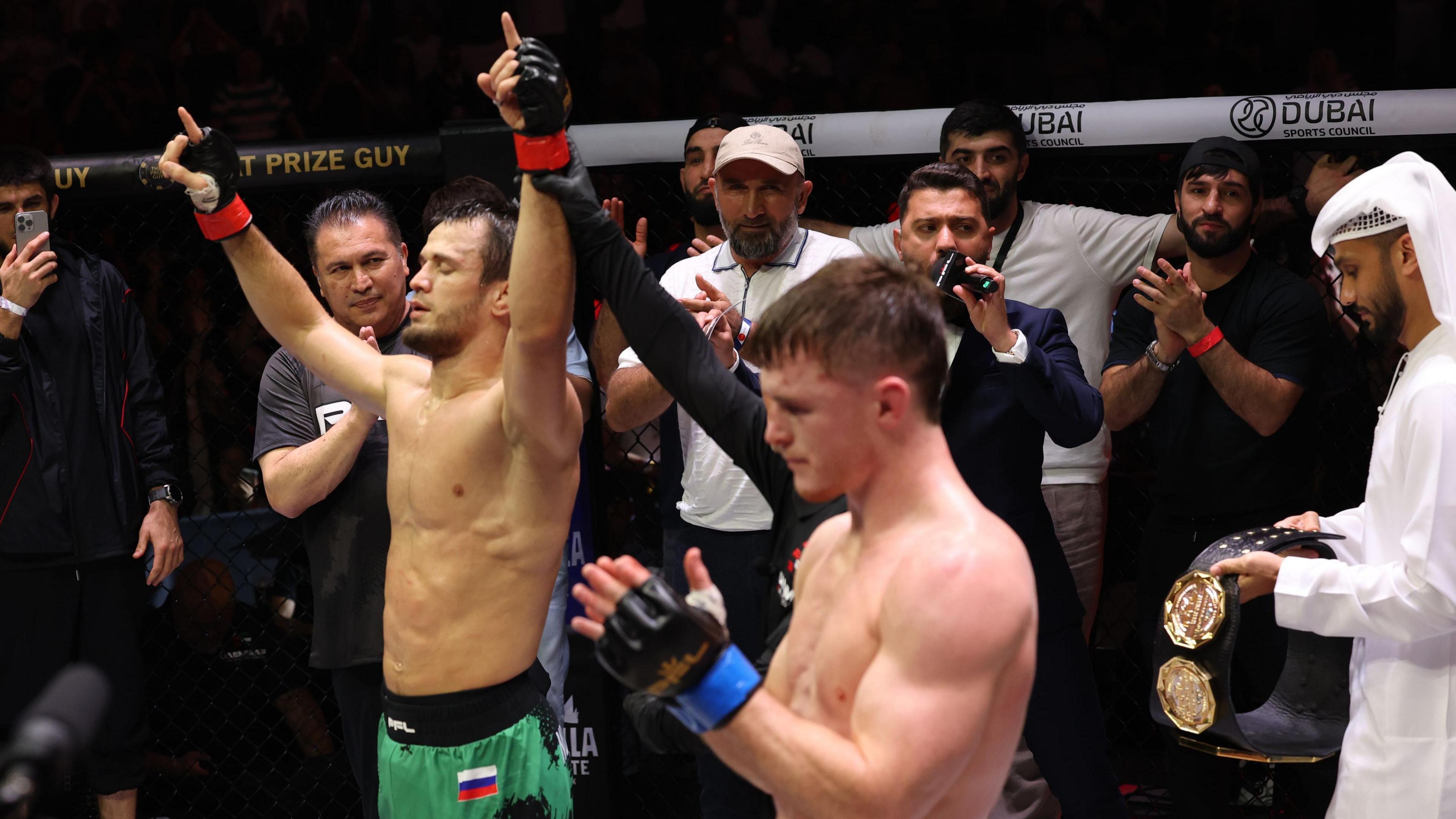 Usman Nurmagomedov celebrates as Paul Hughes applauds