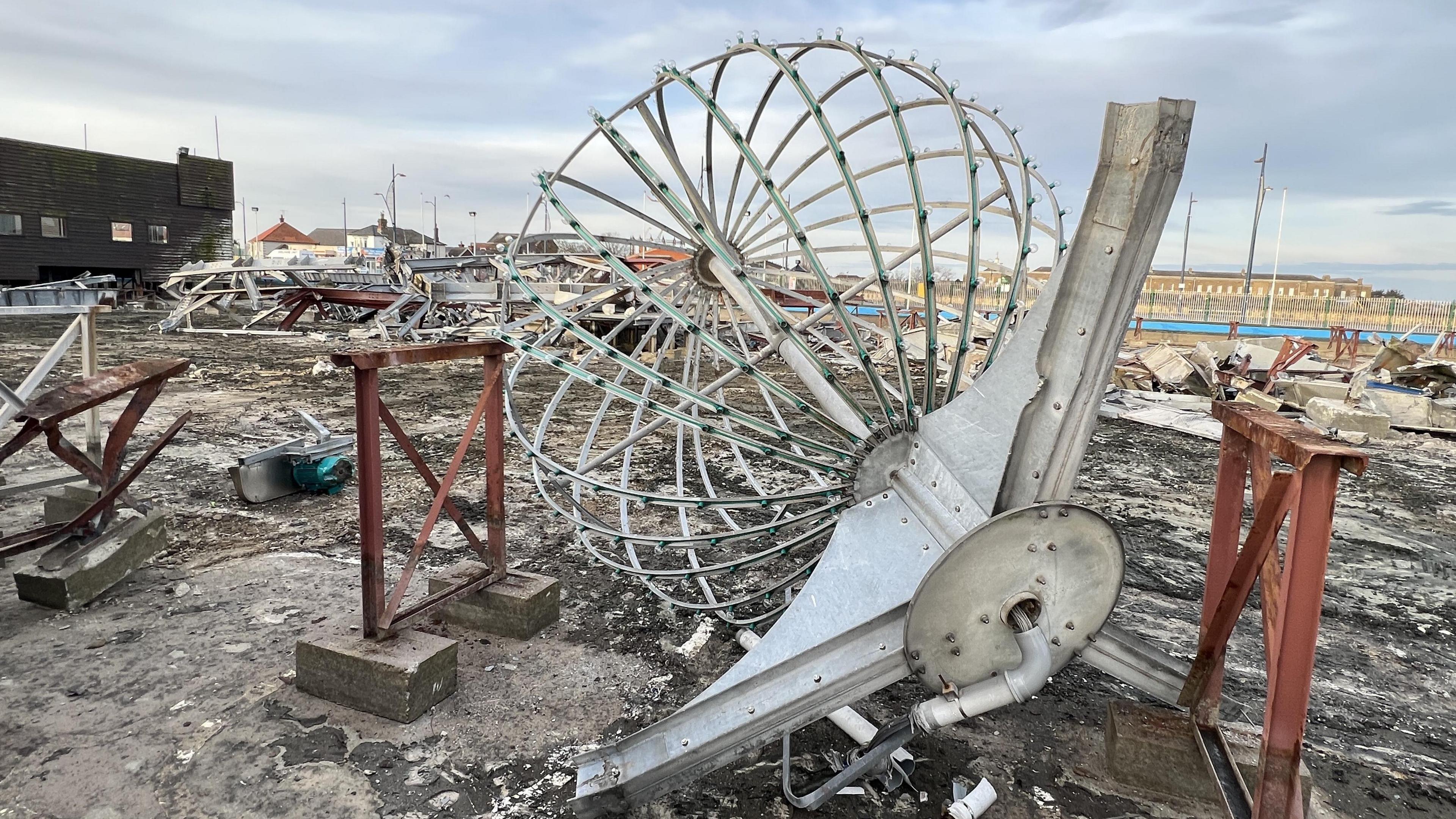 The illuminated ball top from the ride remained intact after the demolition