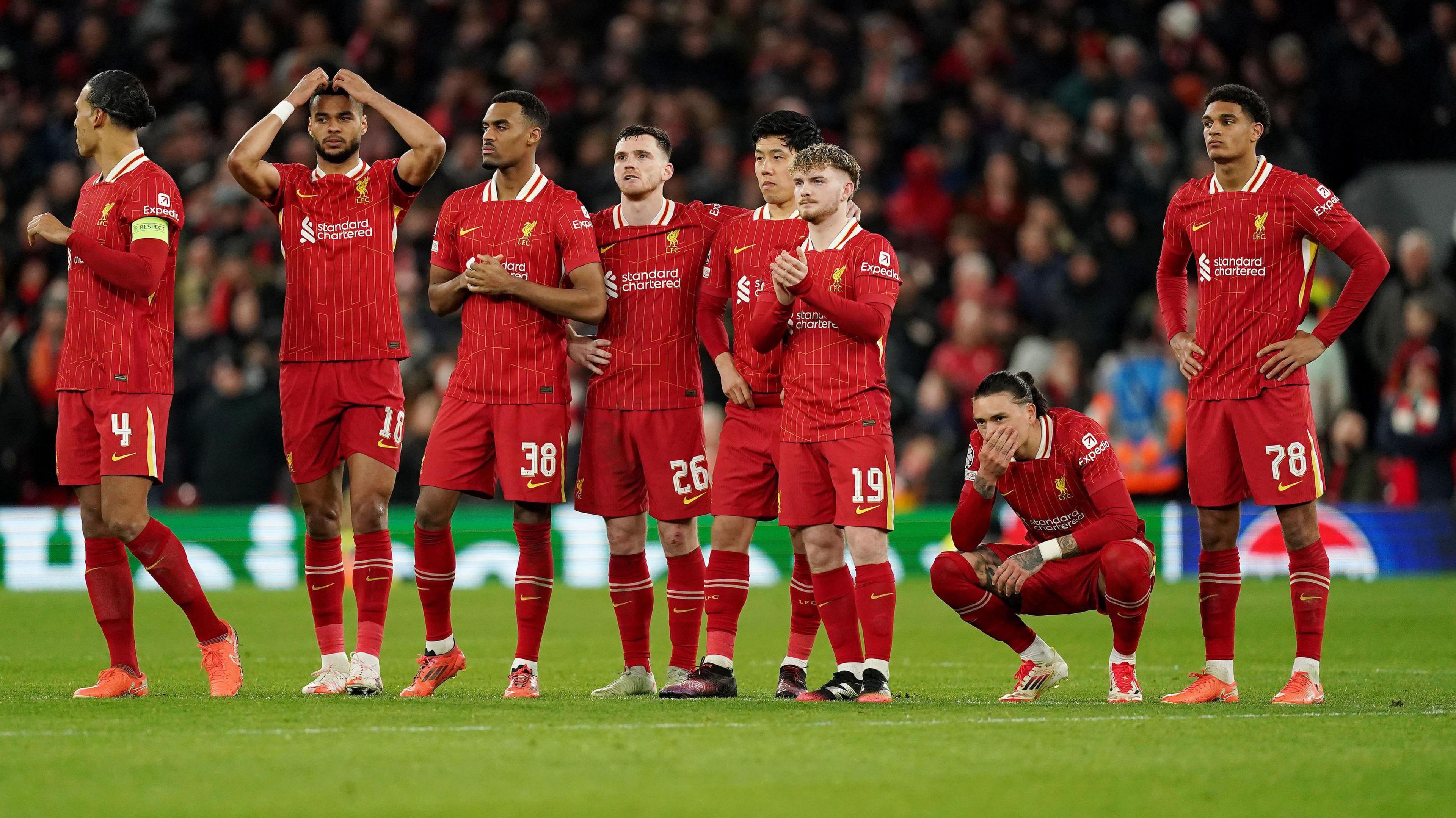 Eight of the Liverpool players look upset after losing to Paris St-Germain in a penalty shoot out at Anfield. 