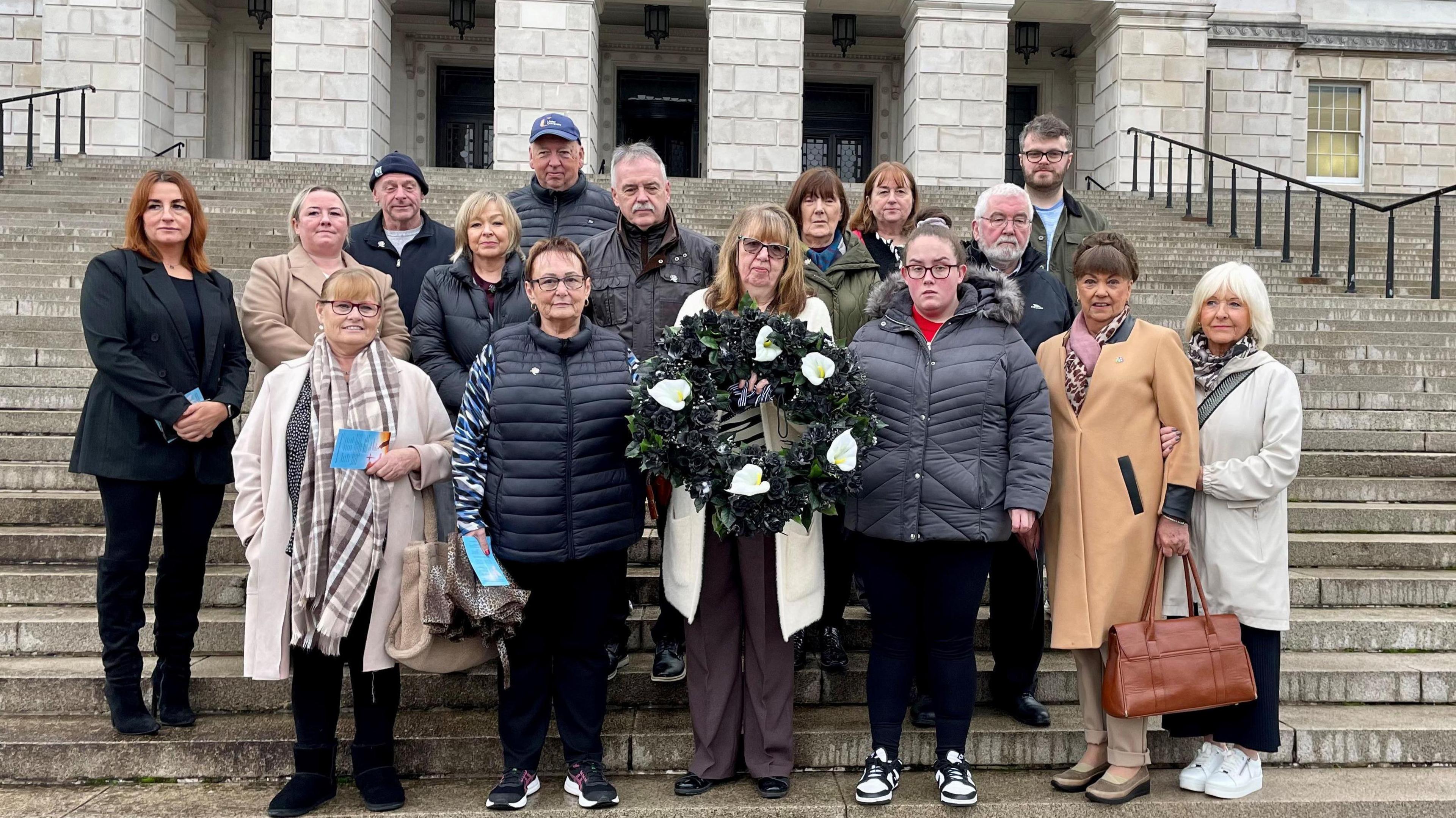 Dympna Kerr, the sister of Disappeared victim Columba McVeigh (holding wreath) and wearing glasses joins families of the Disappeared victims of the Northern Ireland Troubles taking part in their annual All Souls Day silent walk at Stormont to remember the five victims whose remains are yet to be found. 