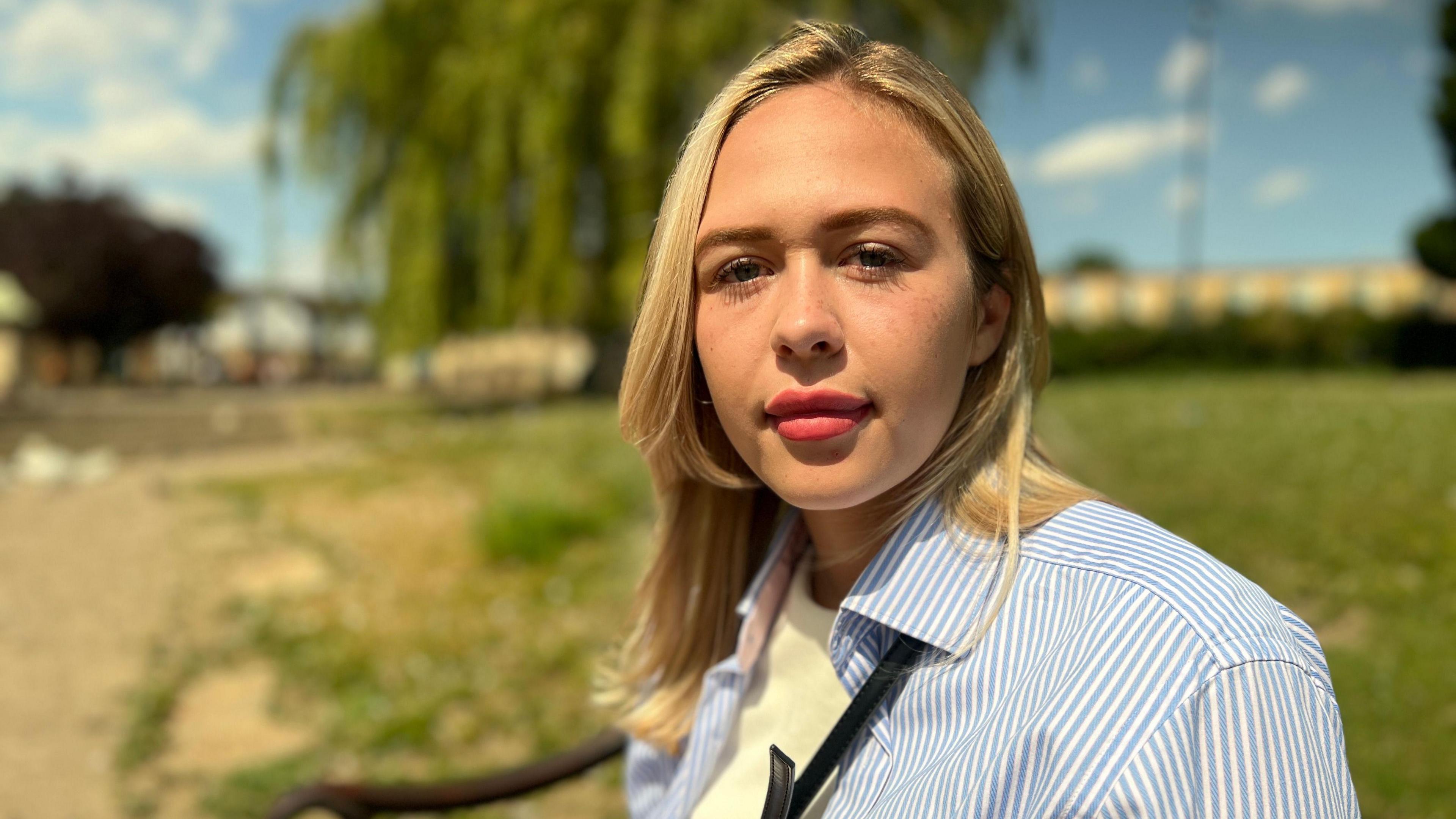 Young female councillor by river bank