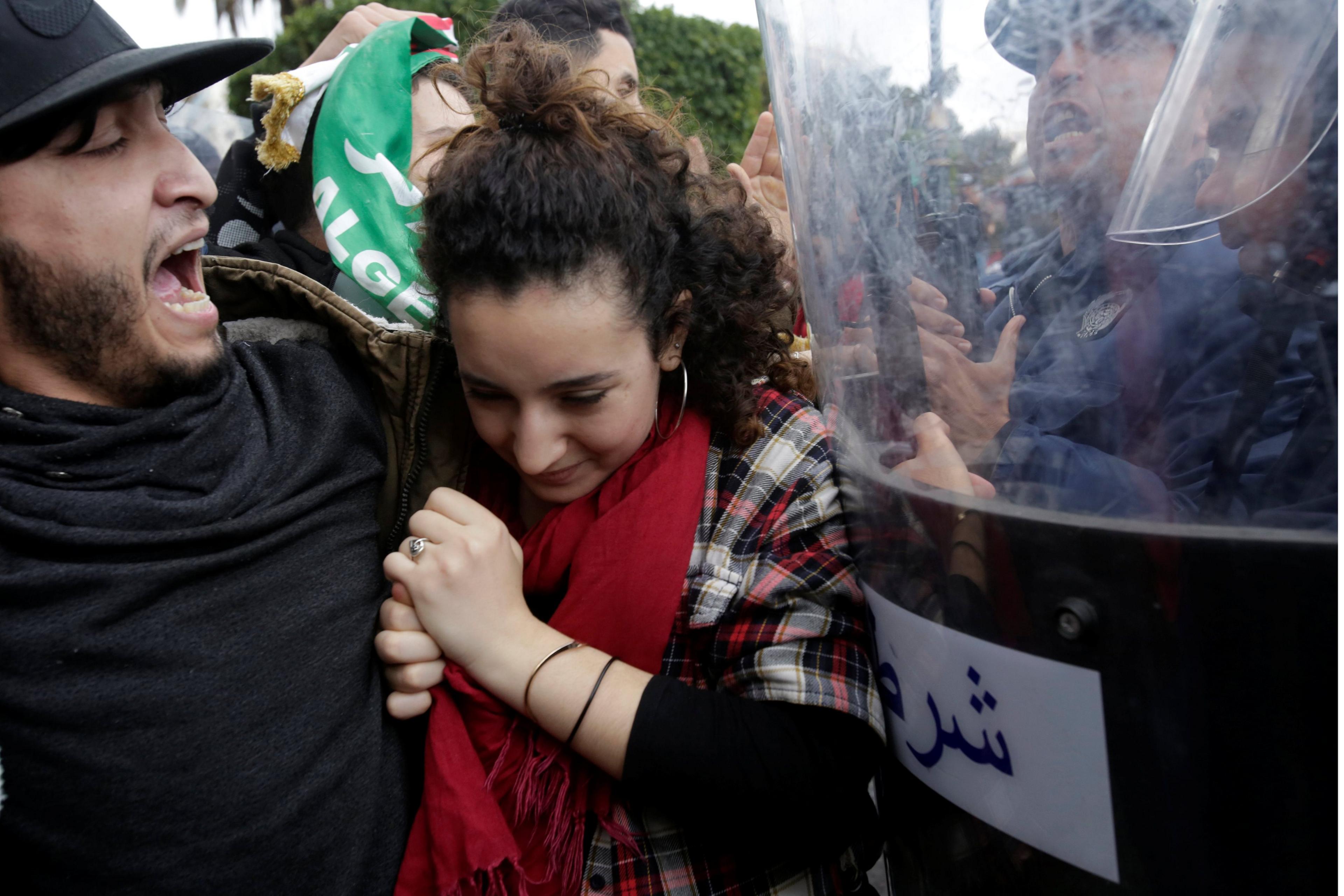 Police stand guard as students protest against the fifth term of Abdelaziz Bouteflika in Algiers