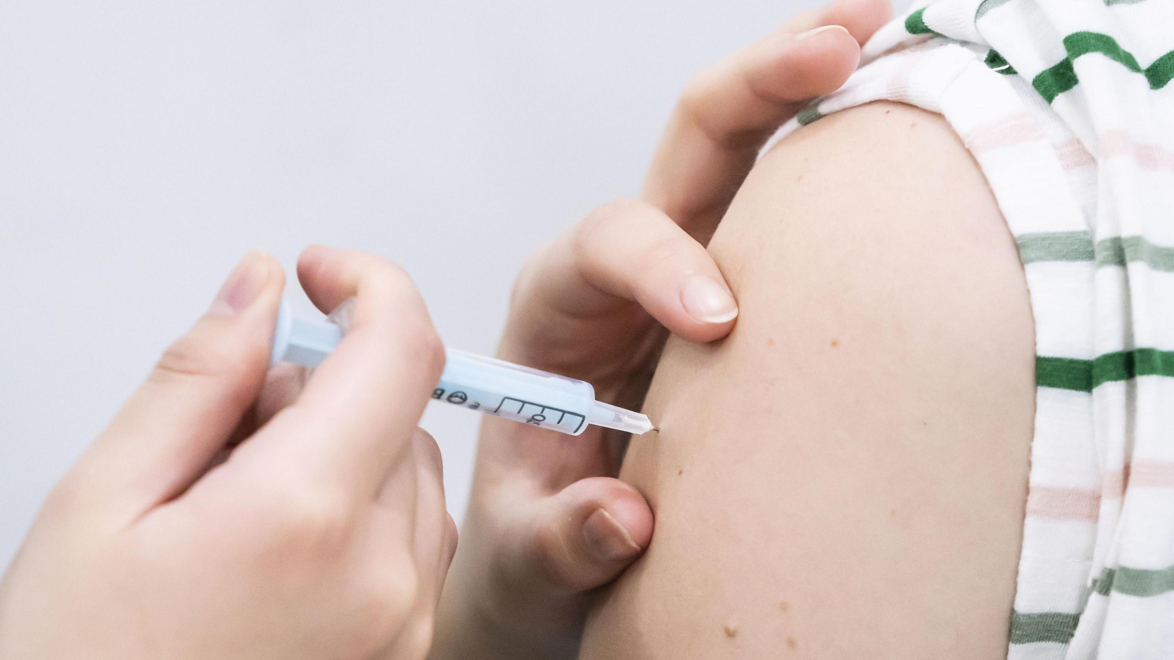 picture of person receiving covid vaccine