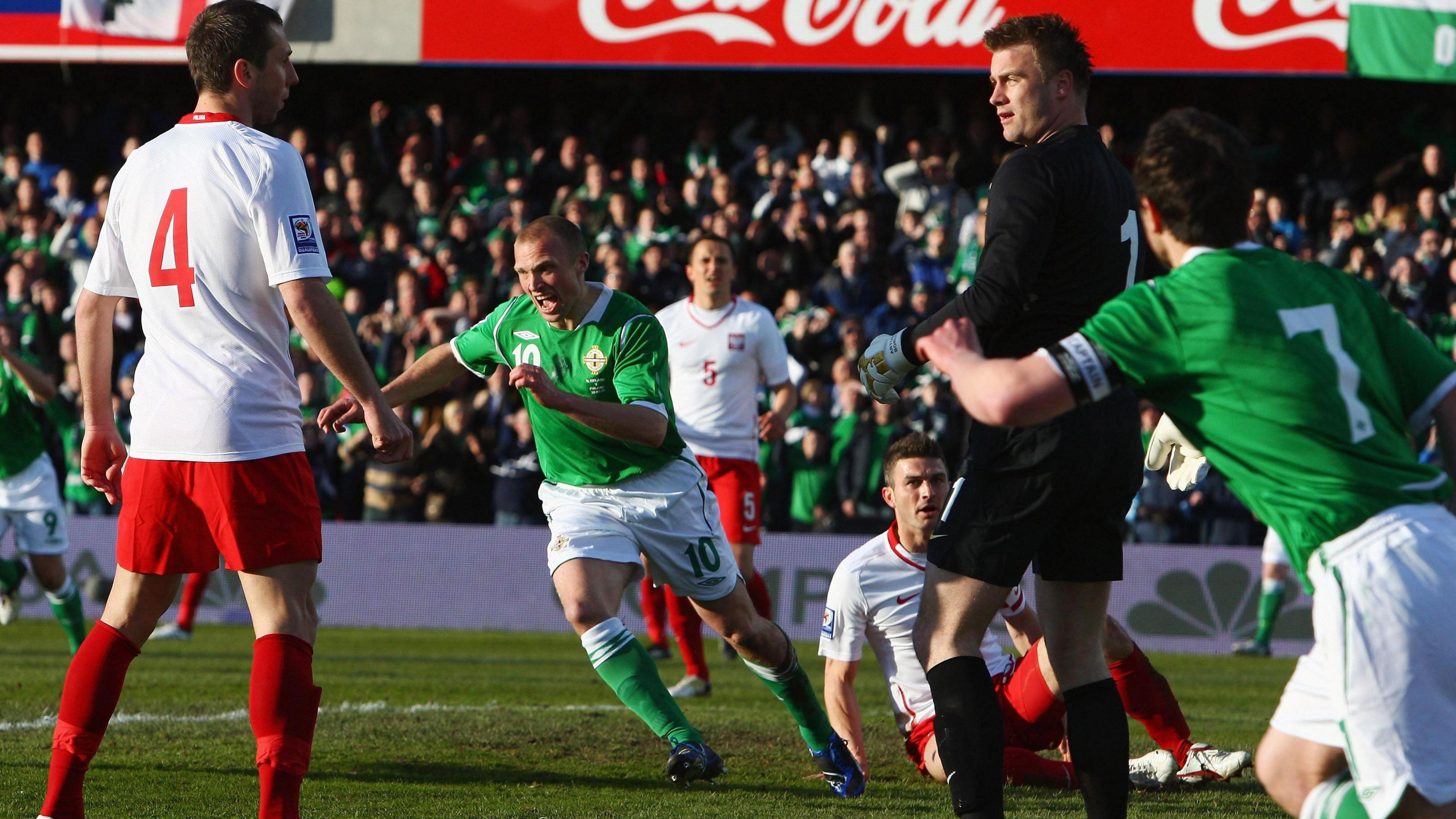 Warren Feeney celebrates a goal against Poland