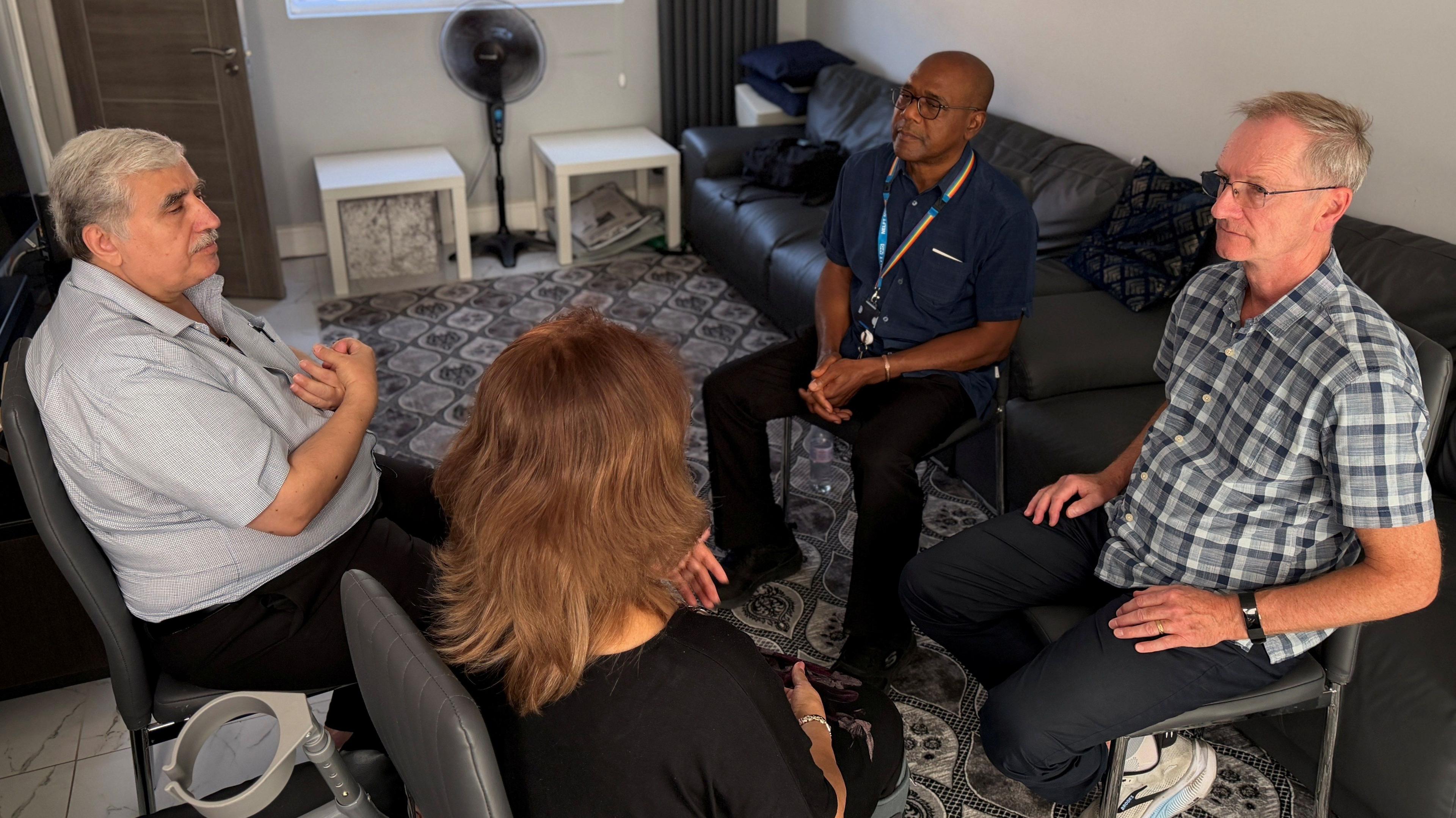 Dr Nihad Fathi, his wife Farah, Dr Bill Travers and community psychiatric nurse David Adebayo sit in a circle