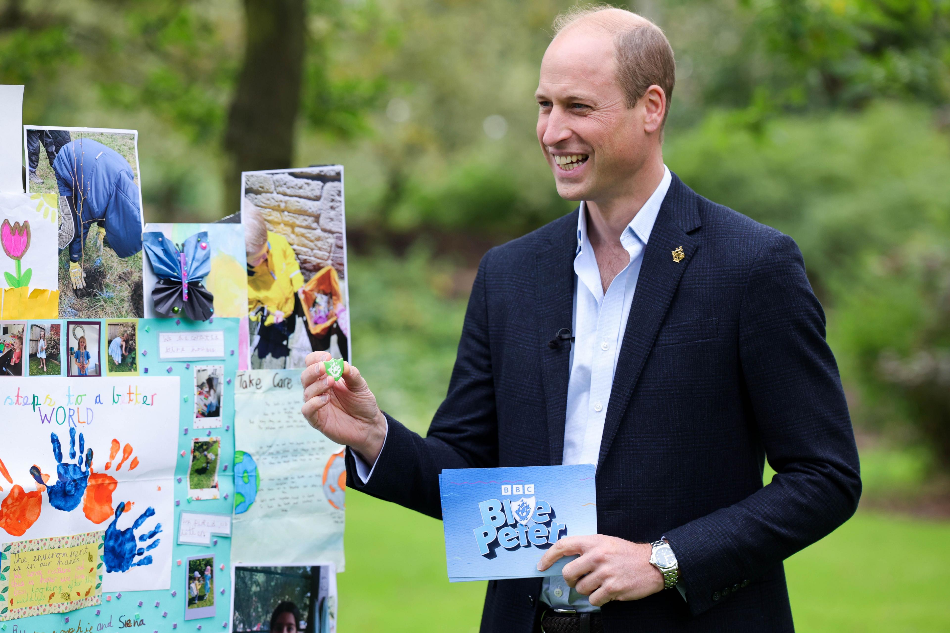 Prince William with Blue Peter cue card and badge. 