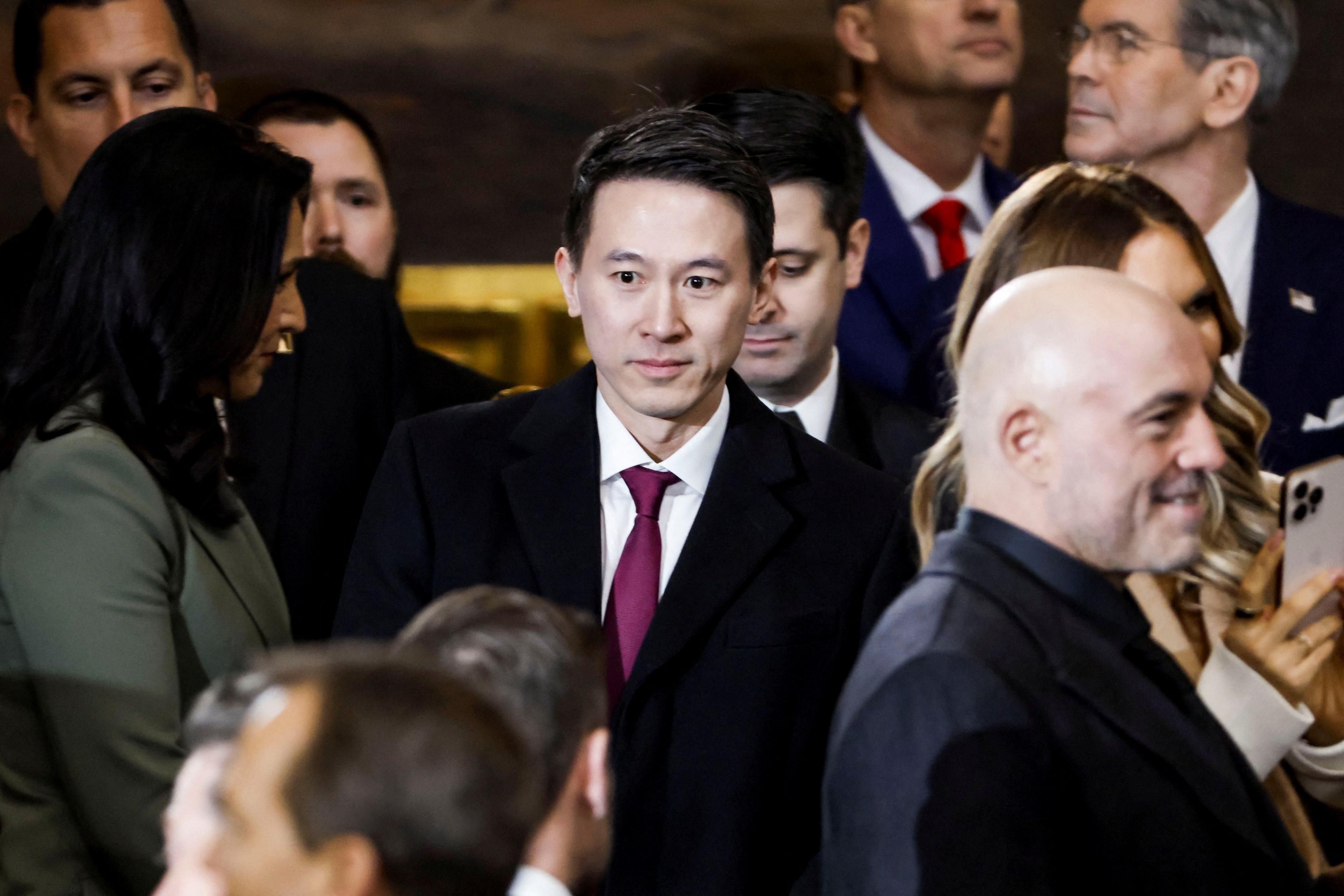 Shou Zi Chew walking through the inauguration crowd, with podcaster Joe Rogan visible in the foreground