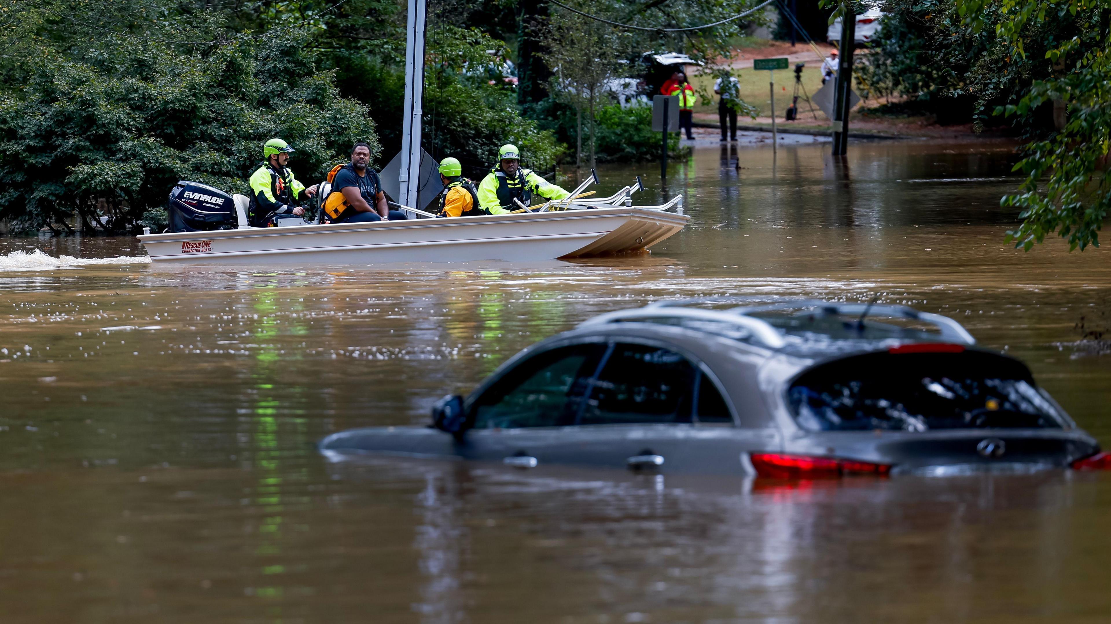 Members of the Atlanta Fire Rescue Department's Water Rescue Team rescue a man in Atlanta, Georgia