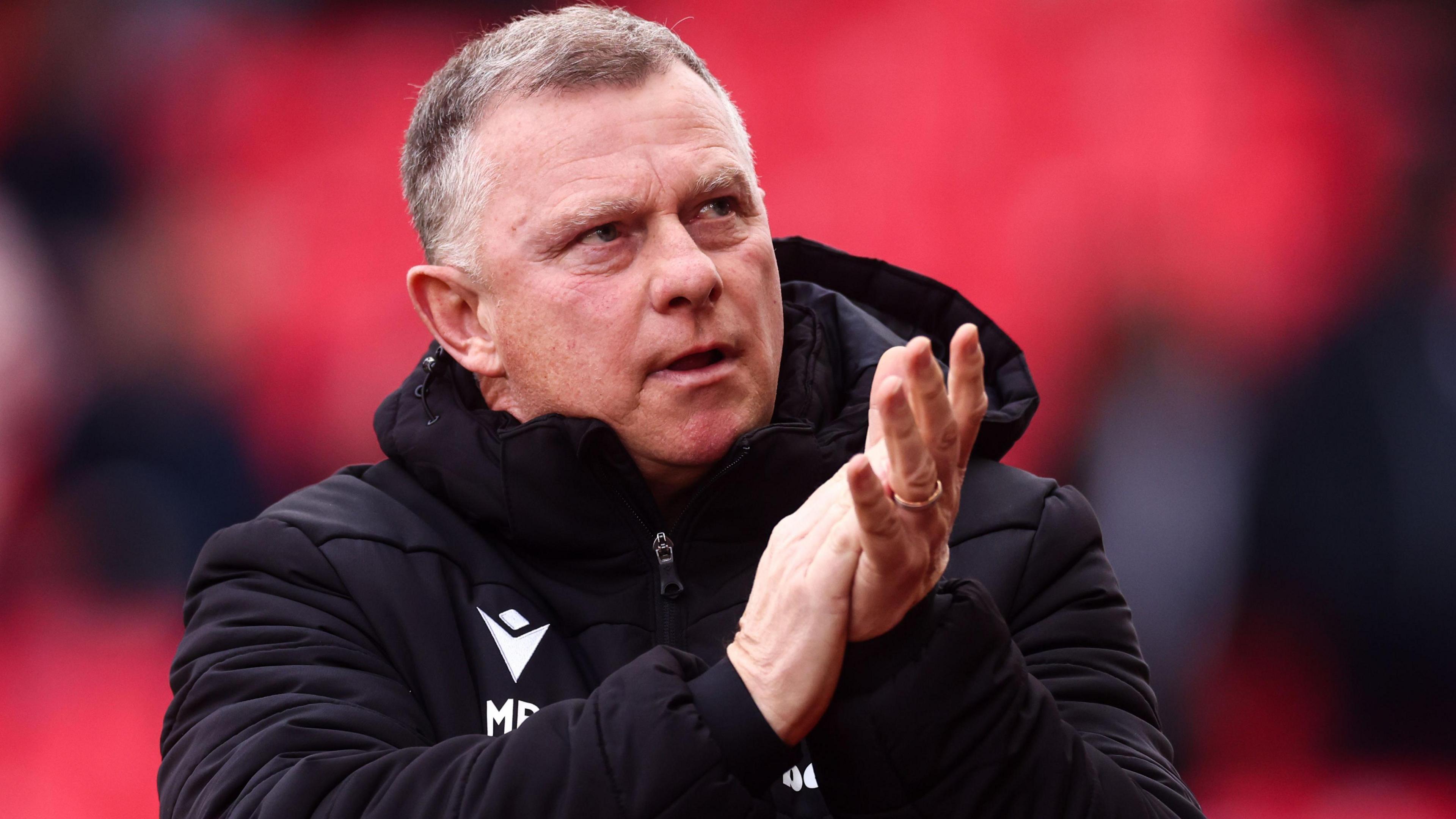 Stoke boss Mark Robins claps supporters