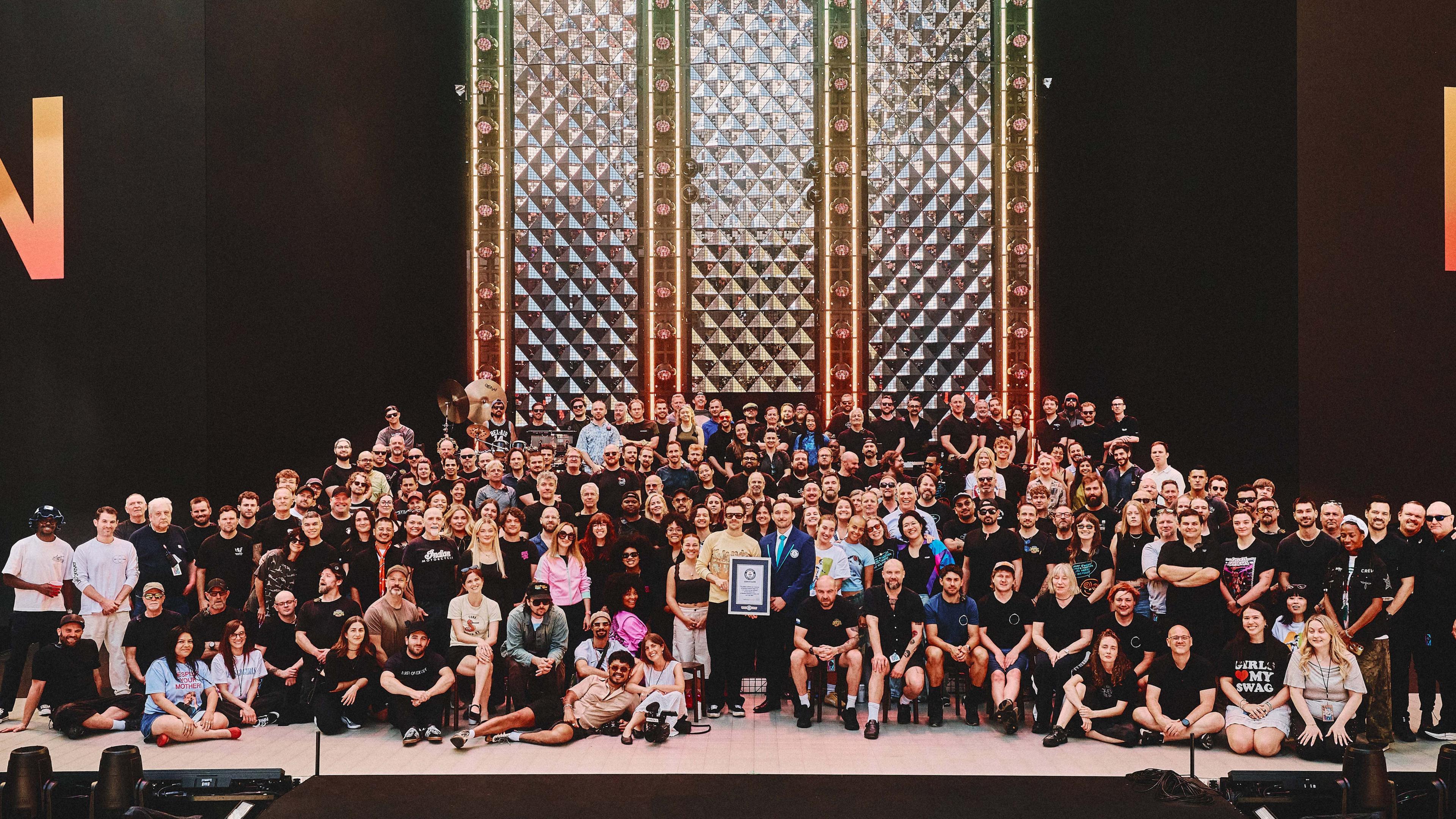 Harry Styles and the touring crew are awarded the Guinness World Records certificate.