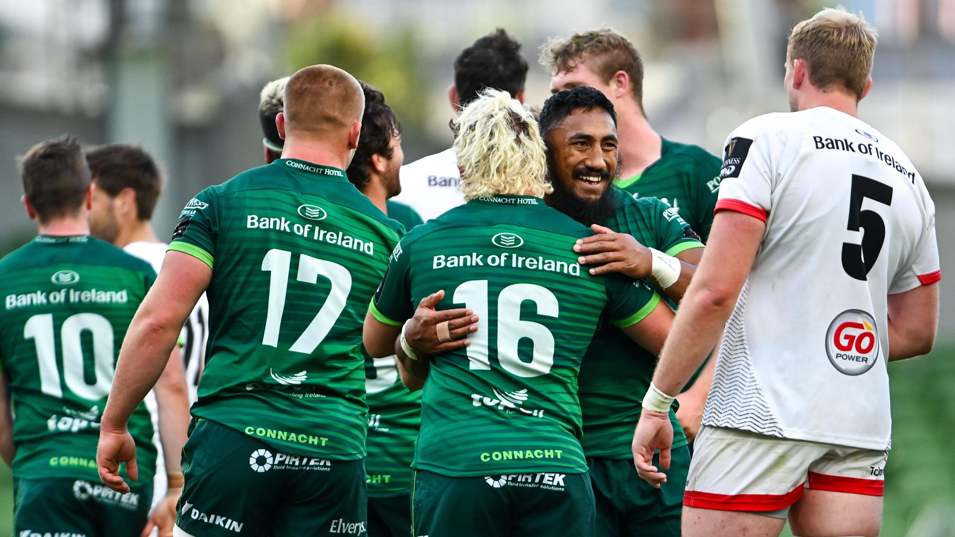 Jonnny Murphy embracing his teammate Bundee Aki with Ulster players in the background. Jonny has blonde hair and is wearing number 16.