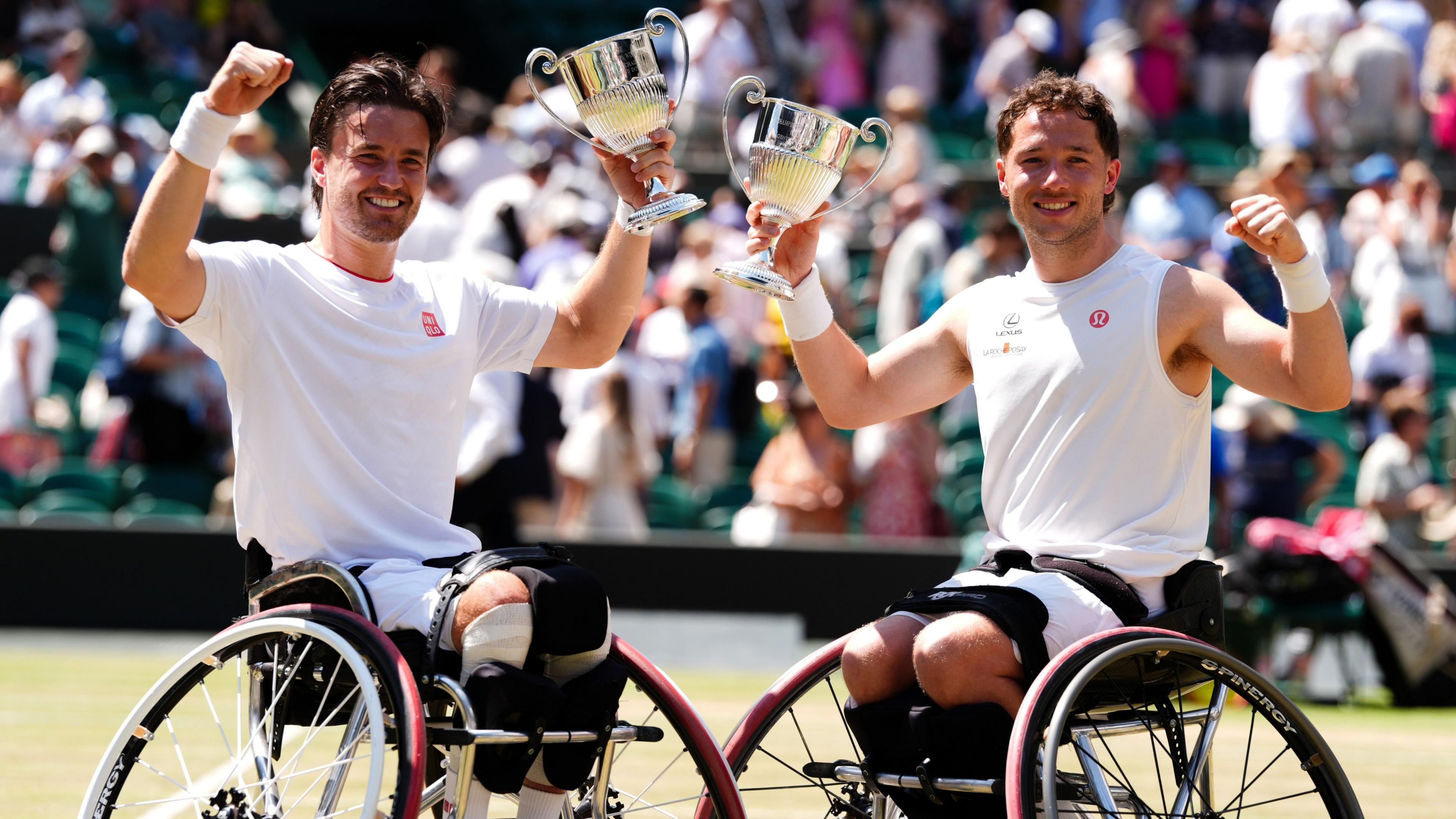 Gordon Reid and Alfie Hewett hold their Wimbledon trophies aloft