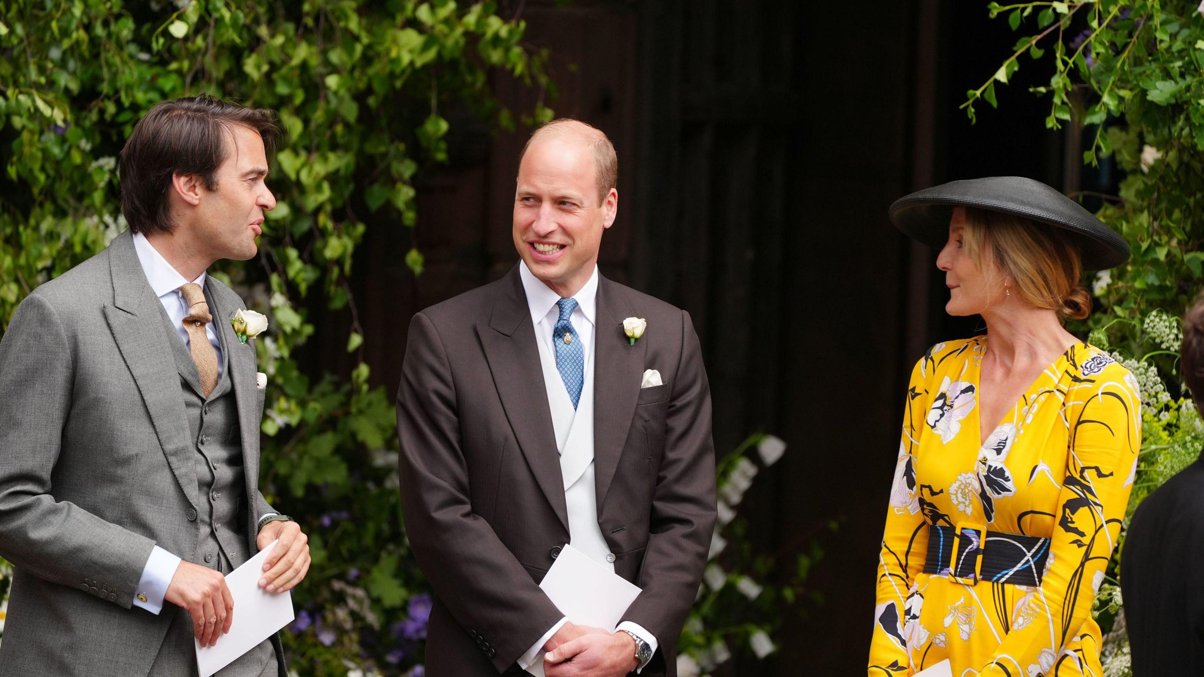 The Prince of Wales (centre) speaks to guests outside the cathedral