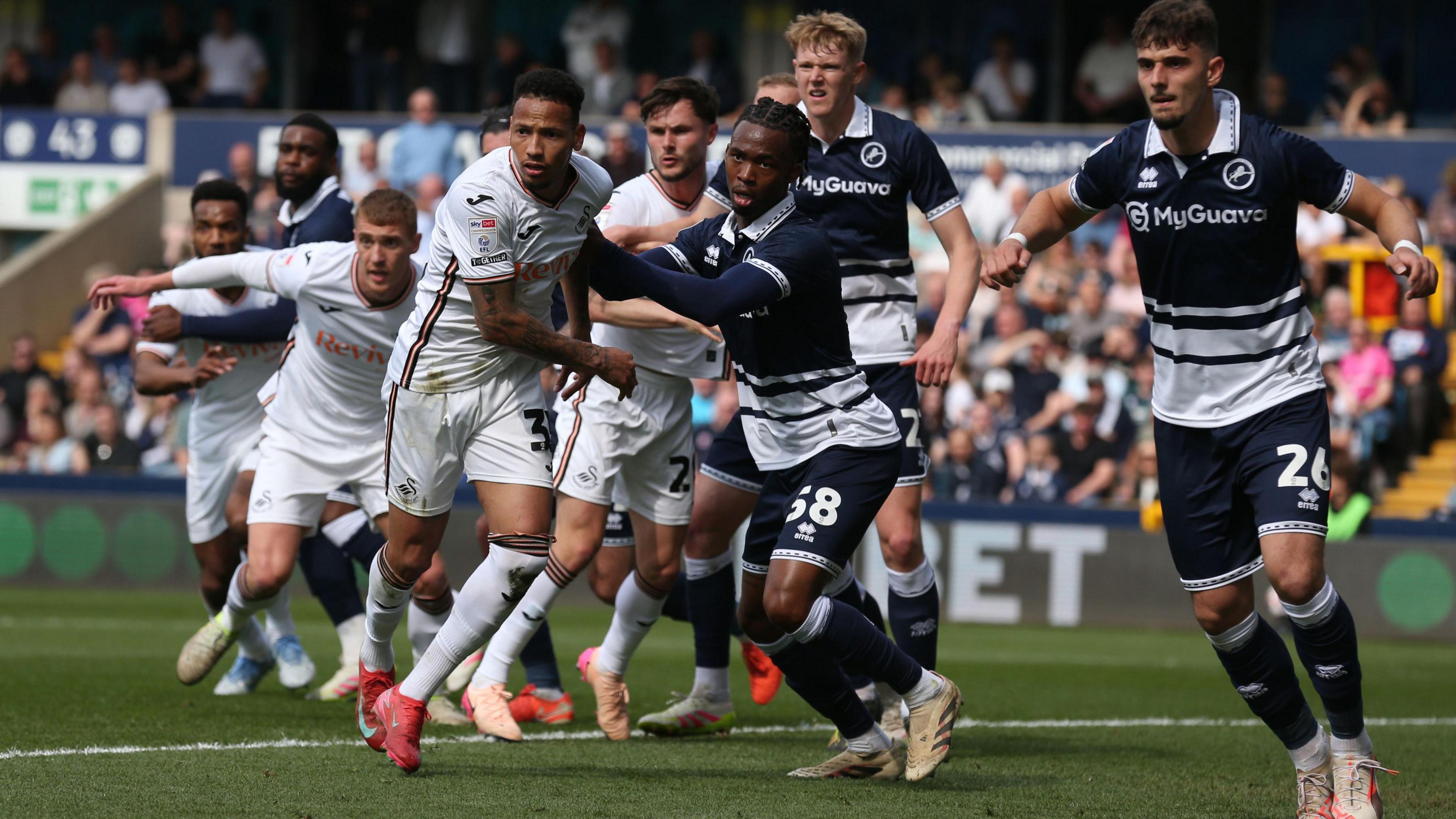 Ronald competes among a crowd of players at a corner