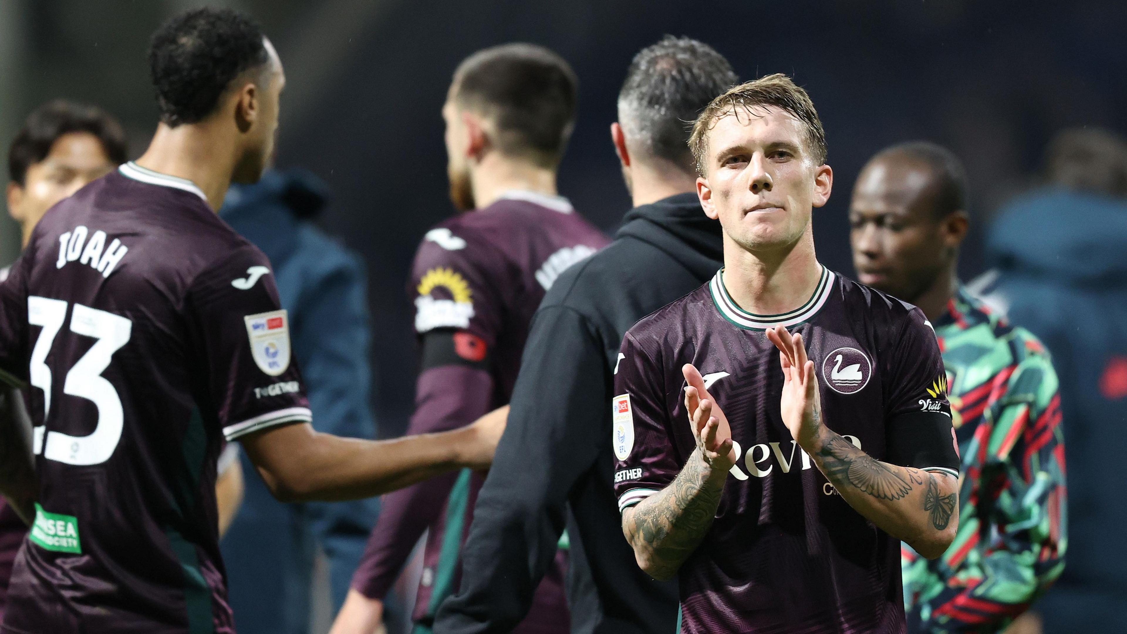 Ethan Galbraith claps Swansea's travelling fans at Preston last week