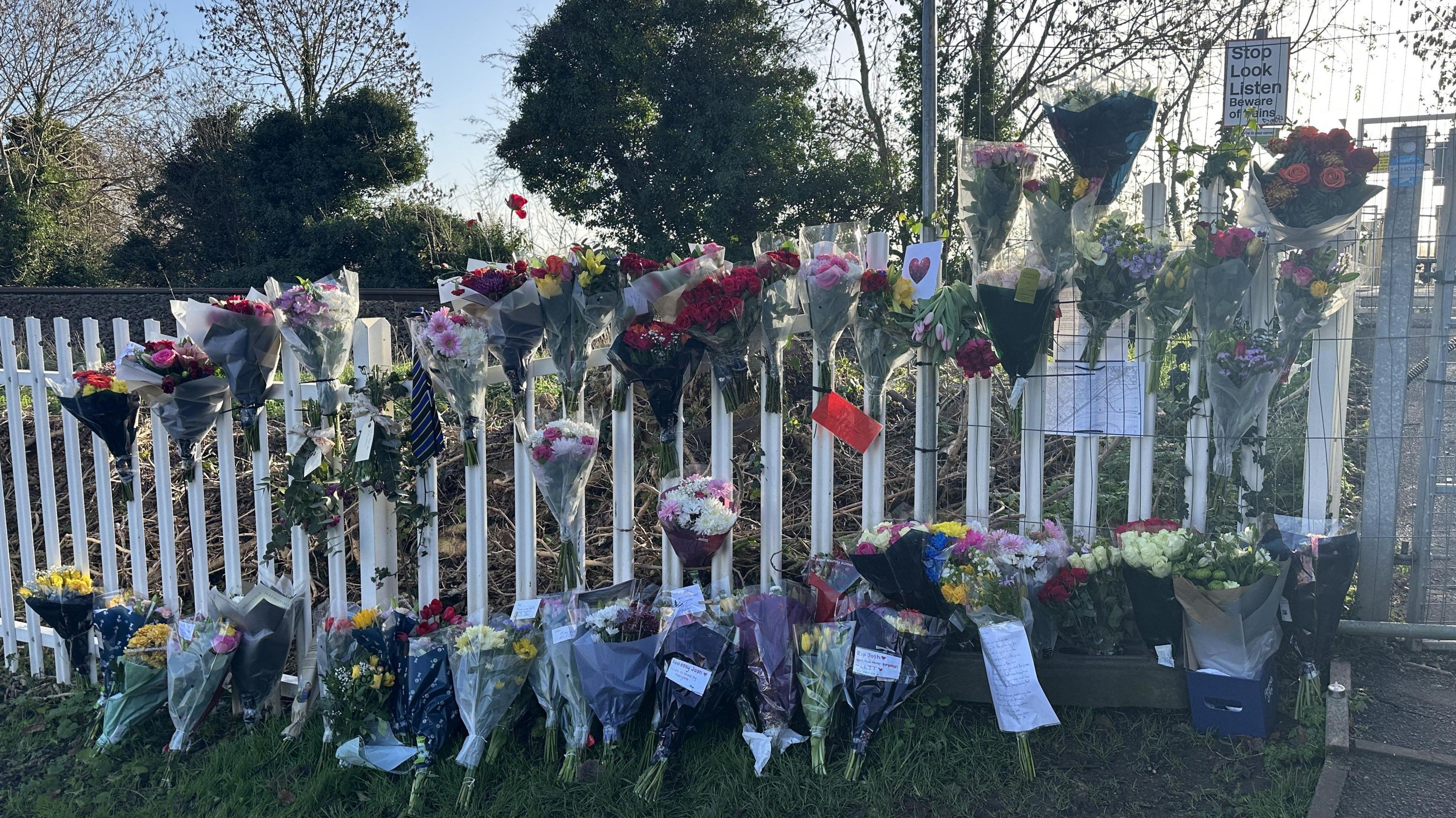 Floral tributes left at the Chestnut Grove footpath railway crossing in Burton Joyce, Nottinghamshire