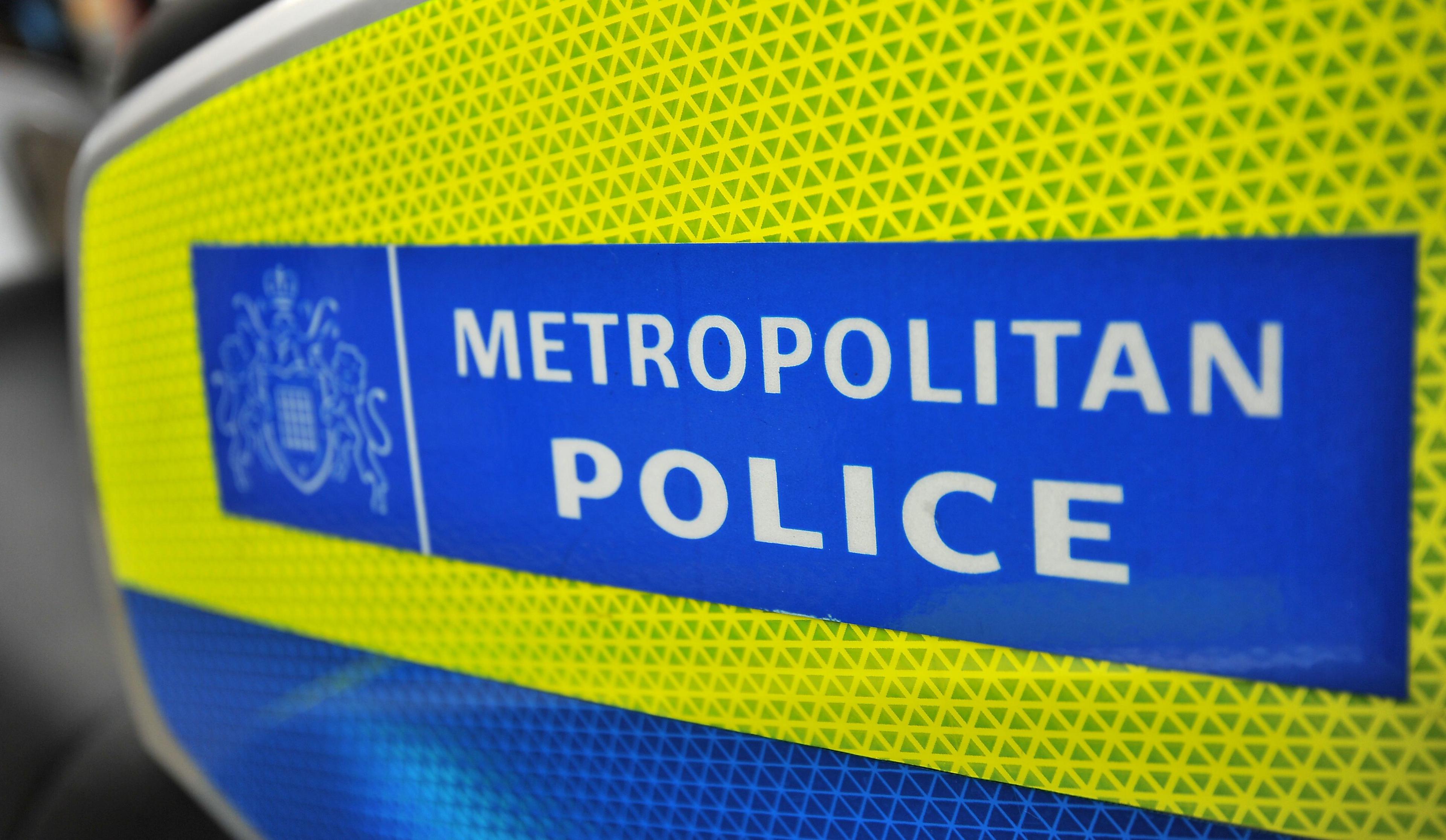 Close-up image of the Metropolitan Police logo, which has white lettering on a blue background and yellow border.