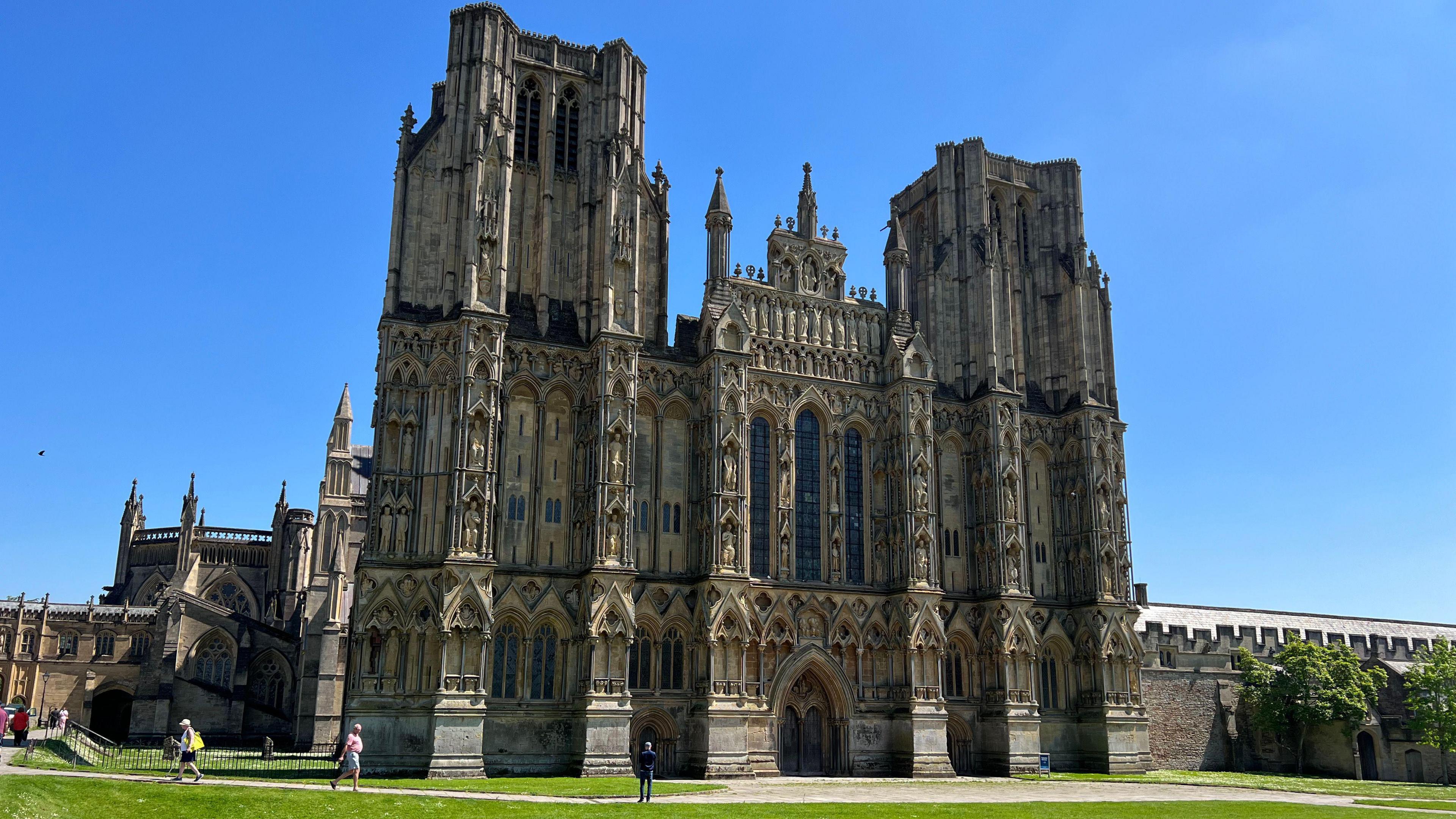 The exterior of Wells Cathedral on a sunny day.