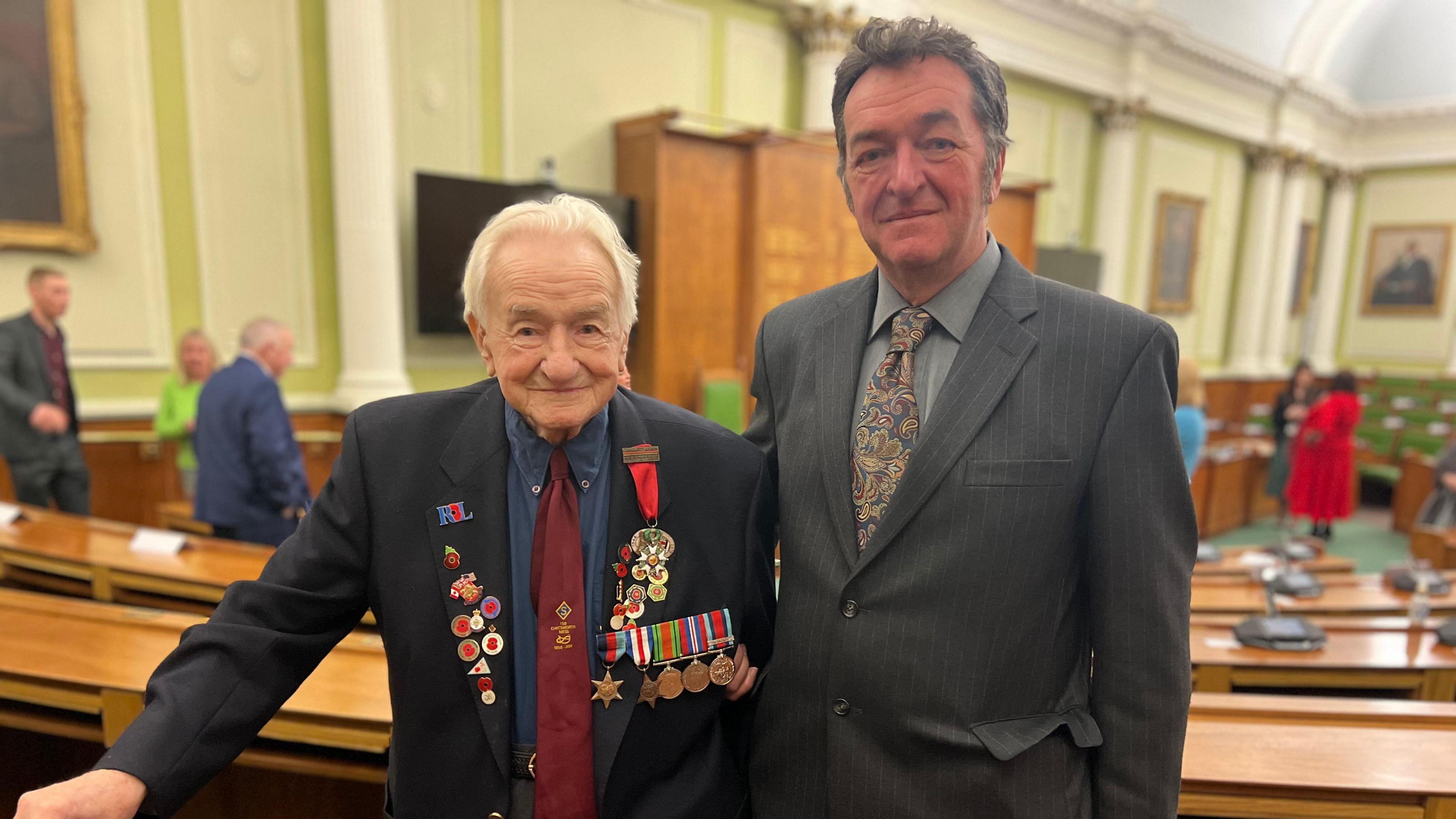 A father and son stood in the council chamber