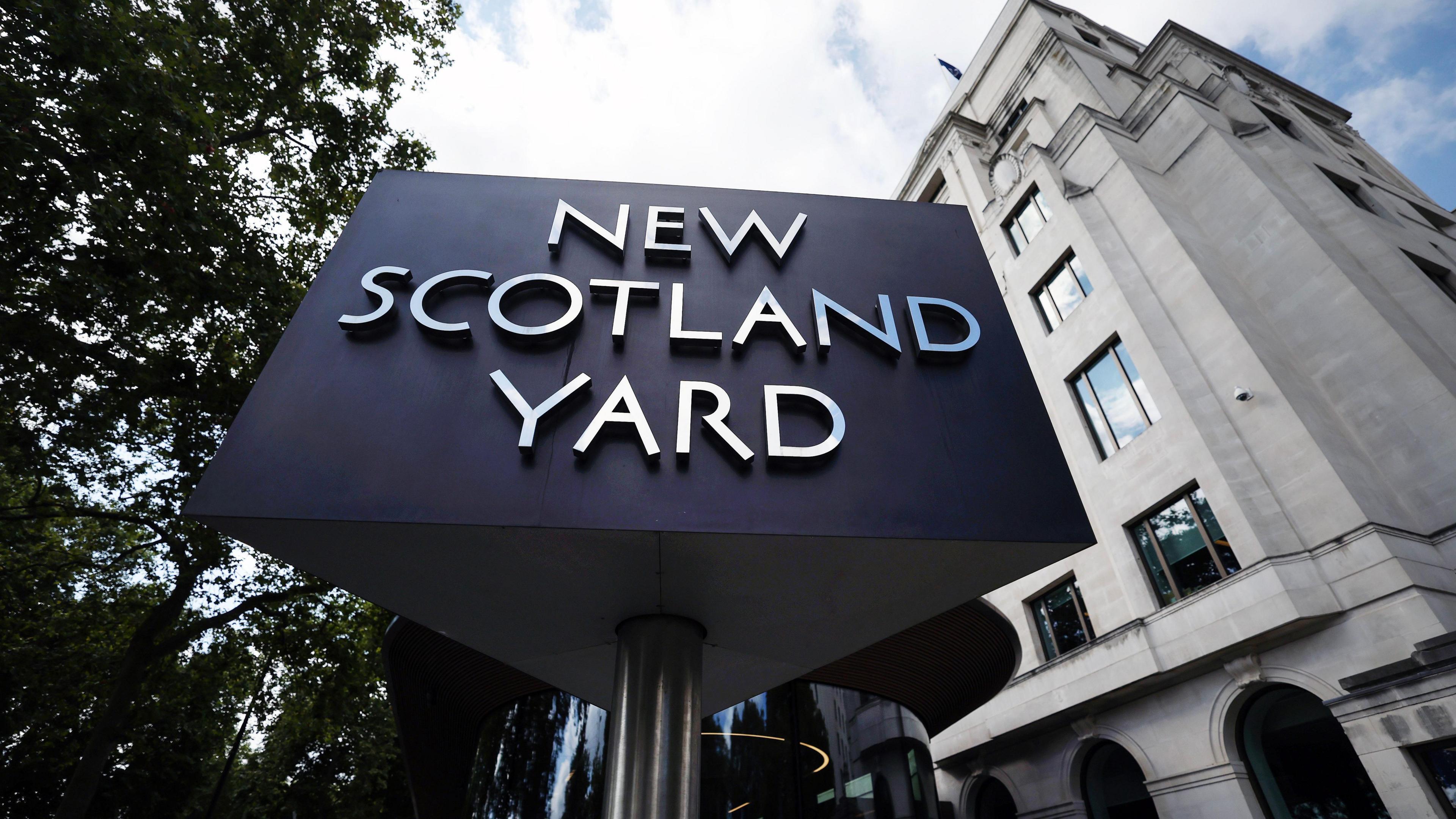 File image showing the three-sided black and silver New Scotland Yard sign outside the Met Police HQ in London