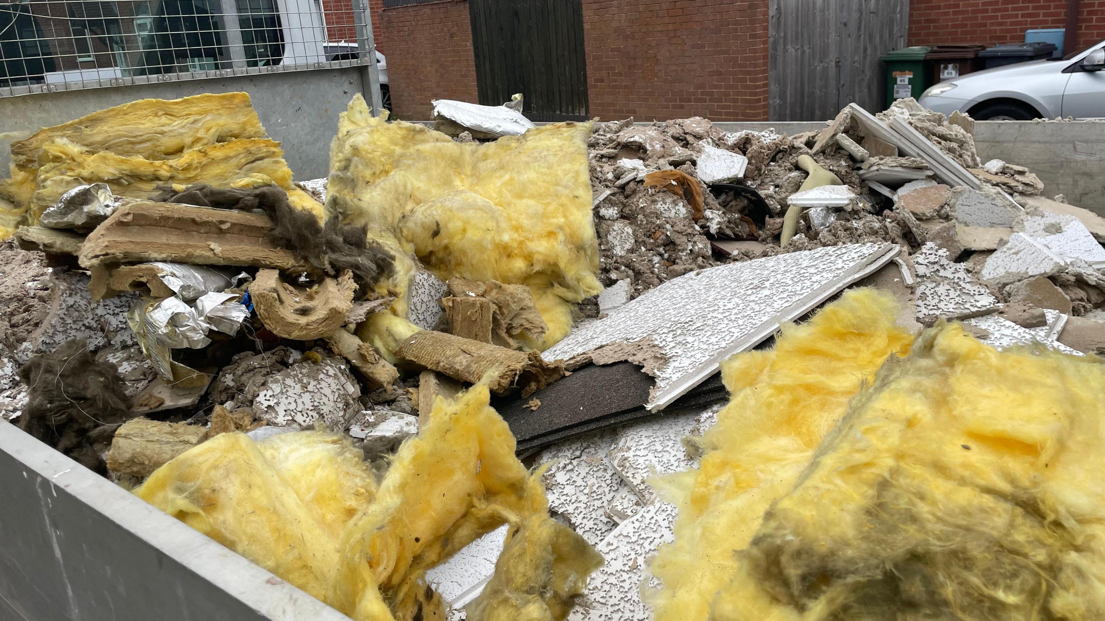 Insulation and broken tiles in the back of a lorry