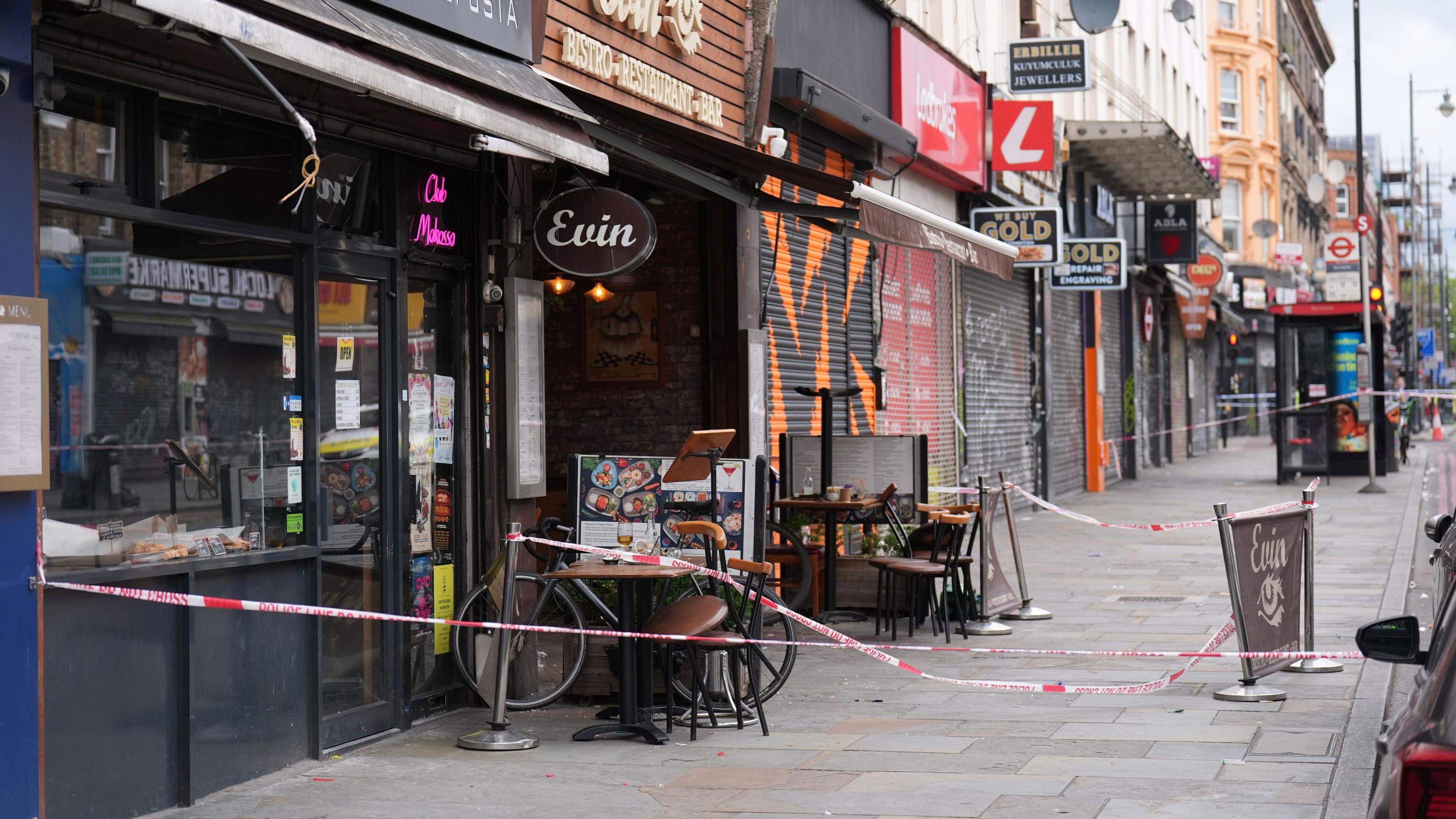 Restaurant where the girl was sitting outside in the days after with police cordon up and table and chairs stacked outside