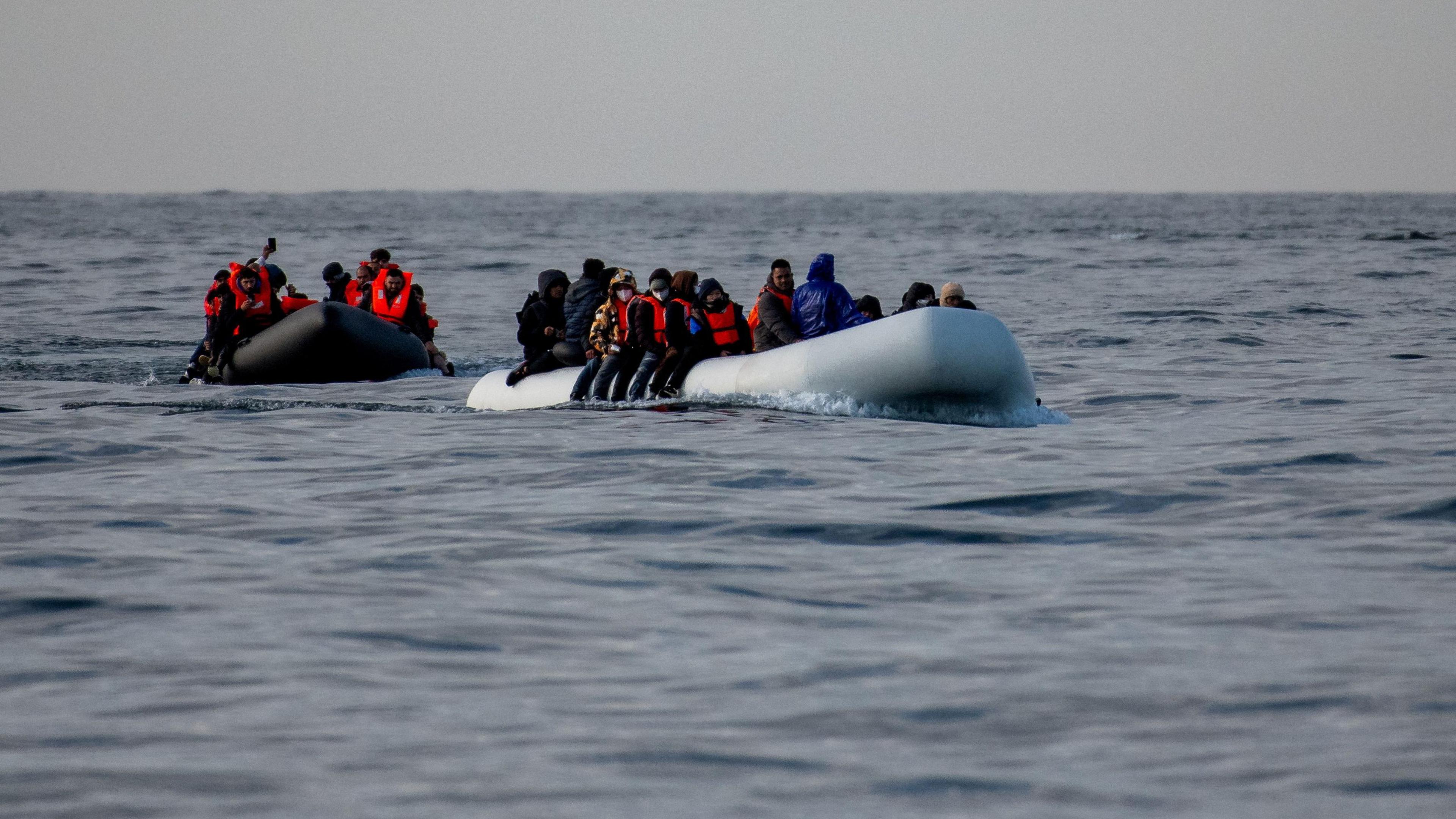 Two inflatable dinghies carrying migrants make their way towards England in the English Channe