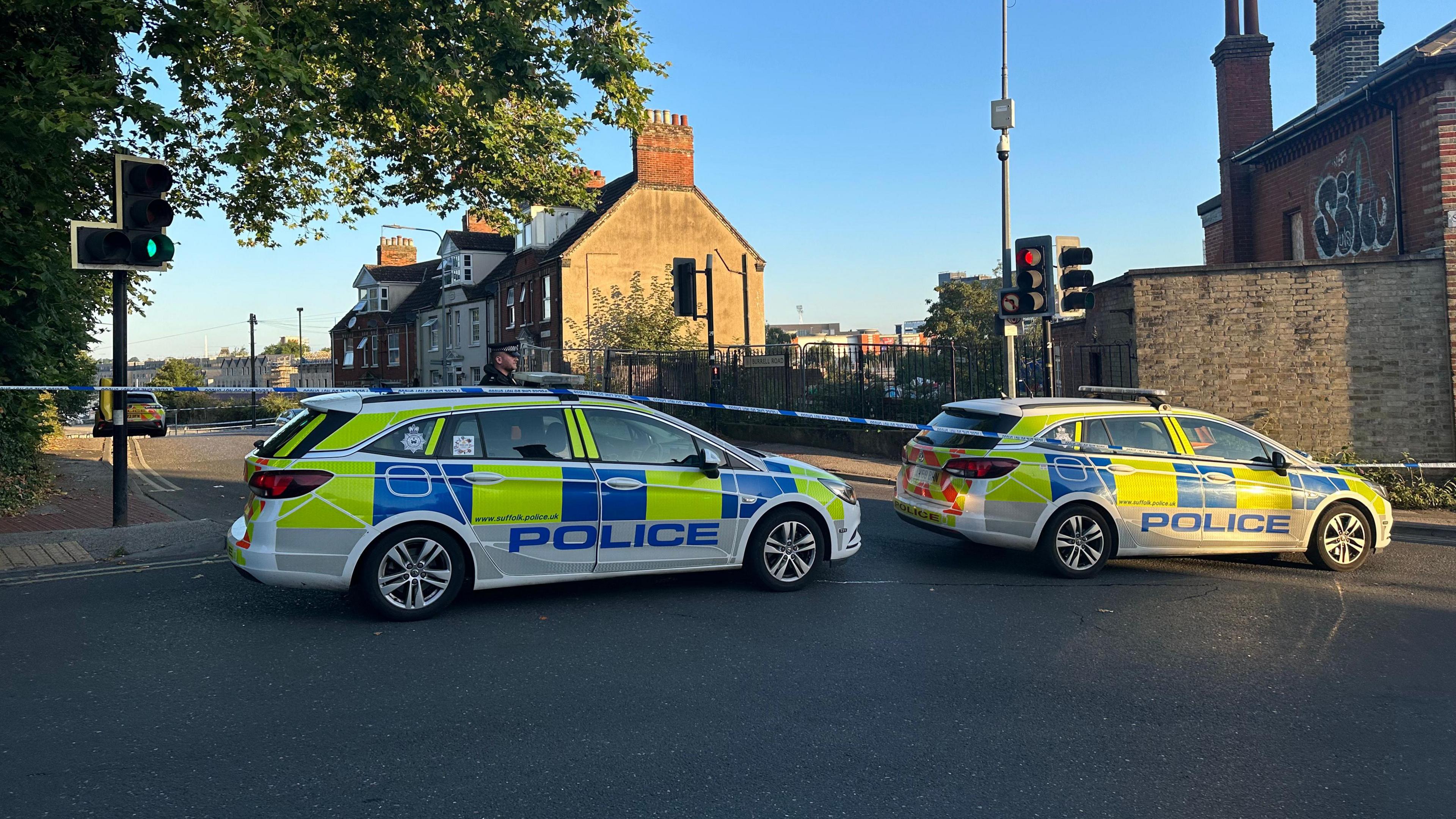 An officer and two police cars at the cordon in Ipswich