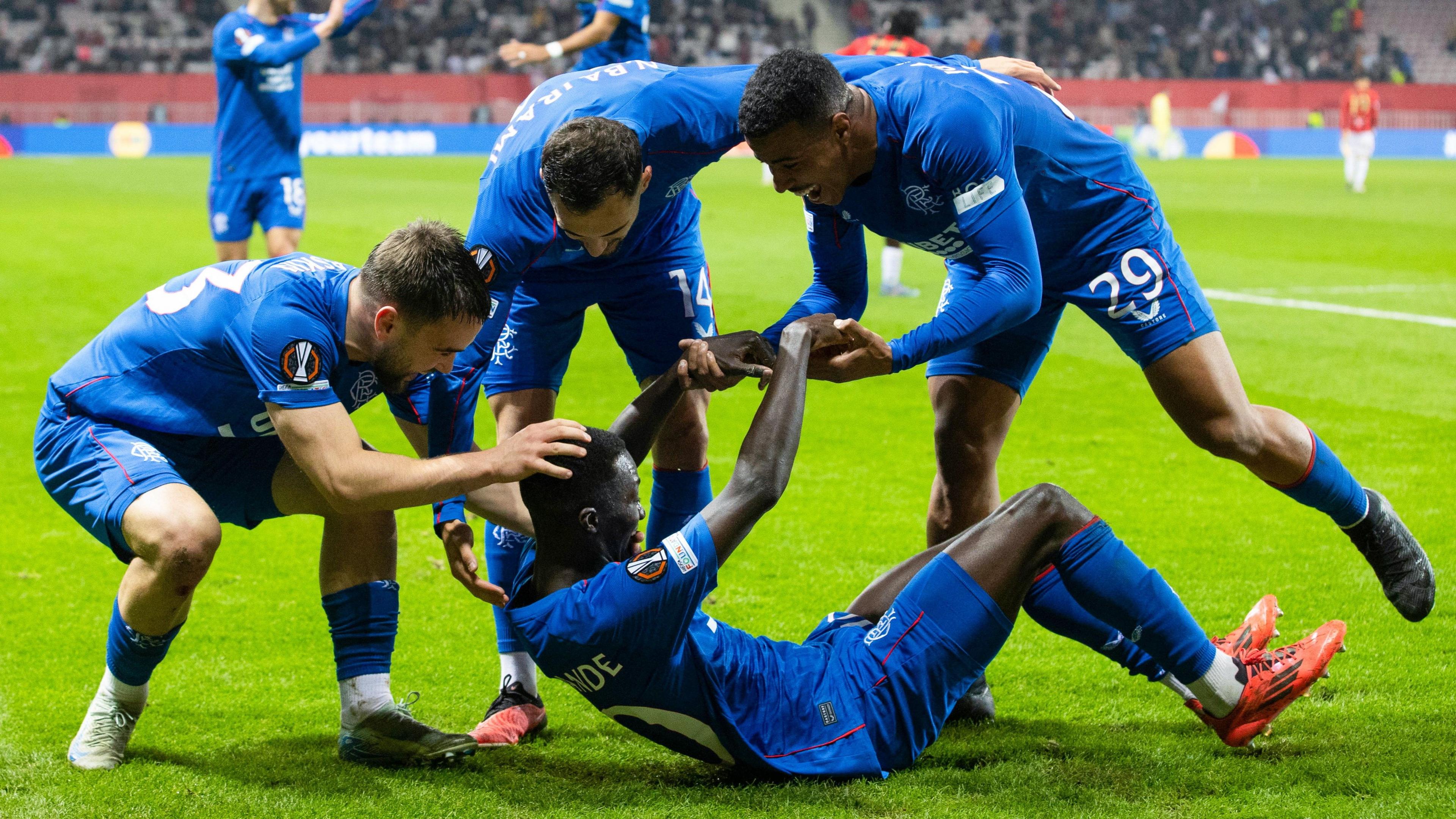 Rangers players celebrate scoring in Nice