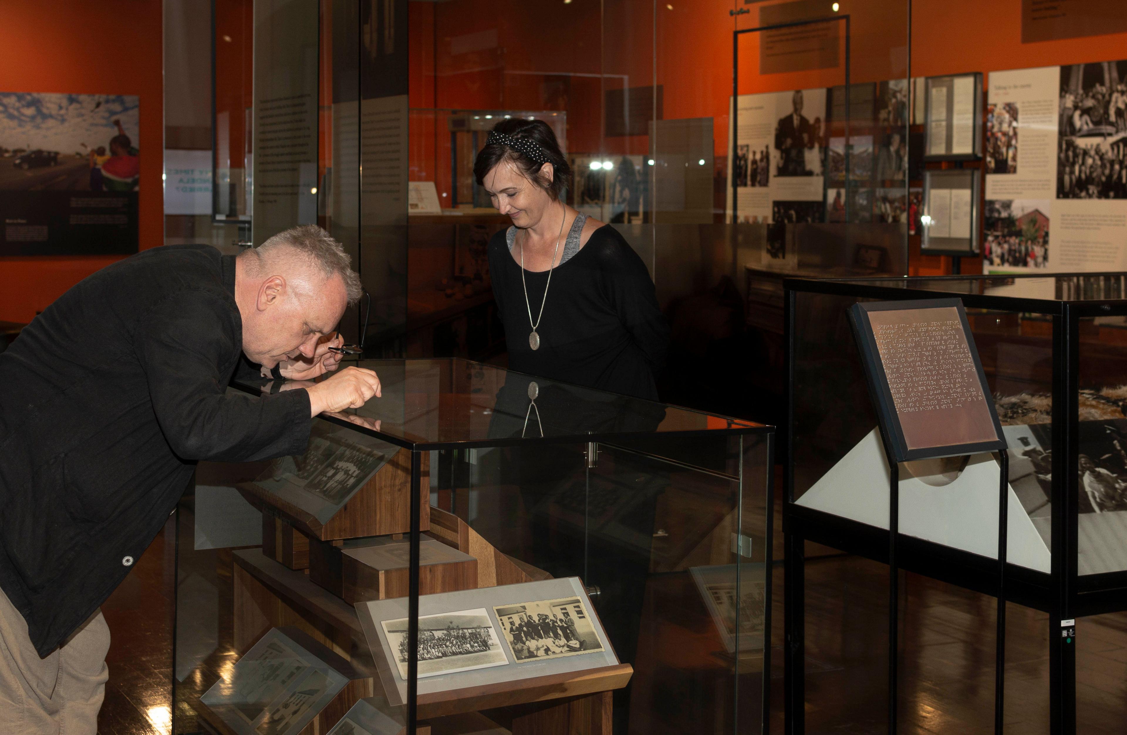 Two academics looking at exhibits in a museum