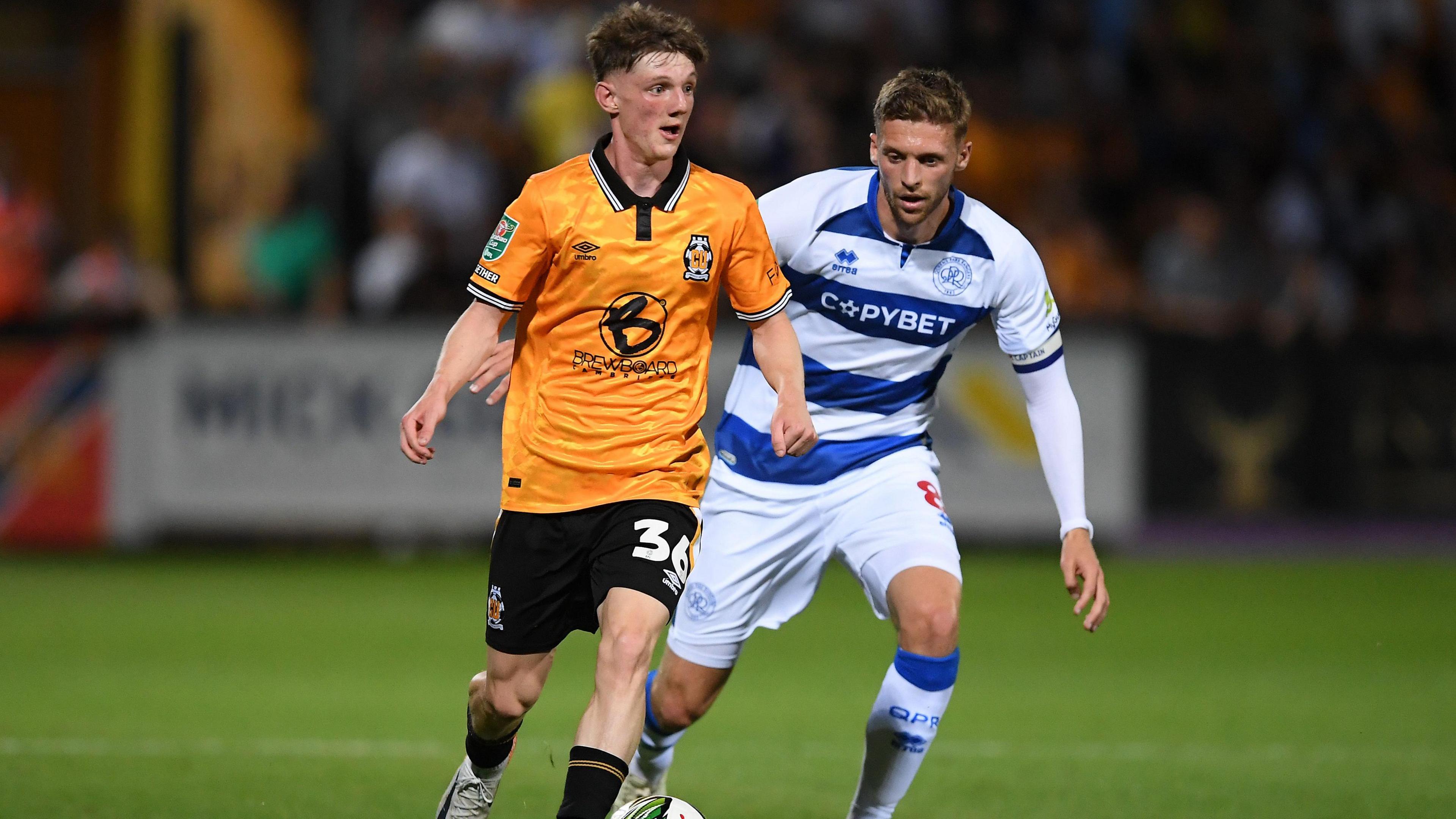 Dan Barton (left) in action for Cambridge against QPR