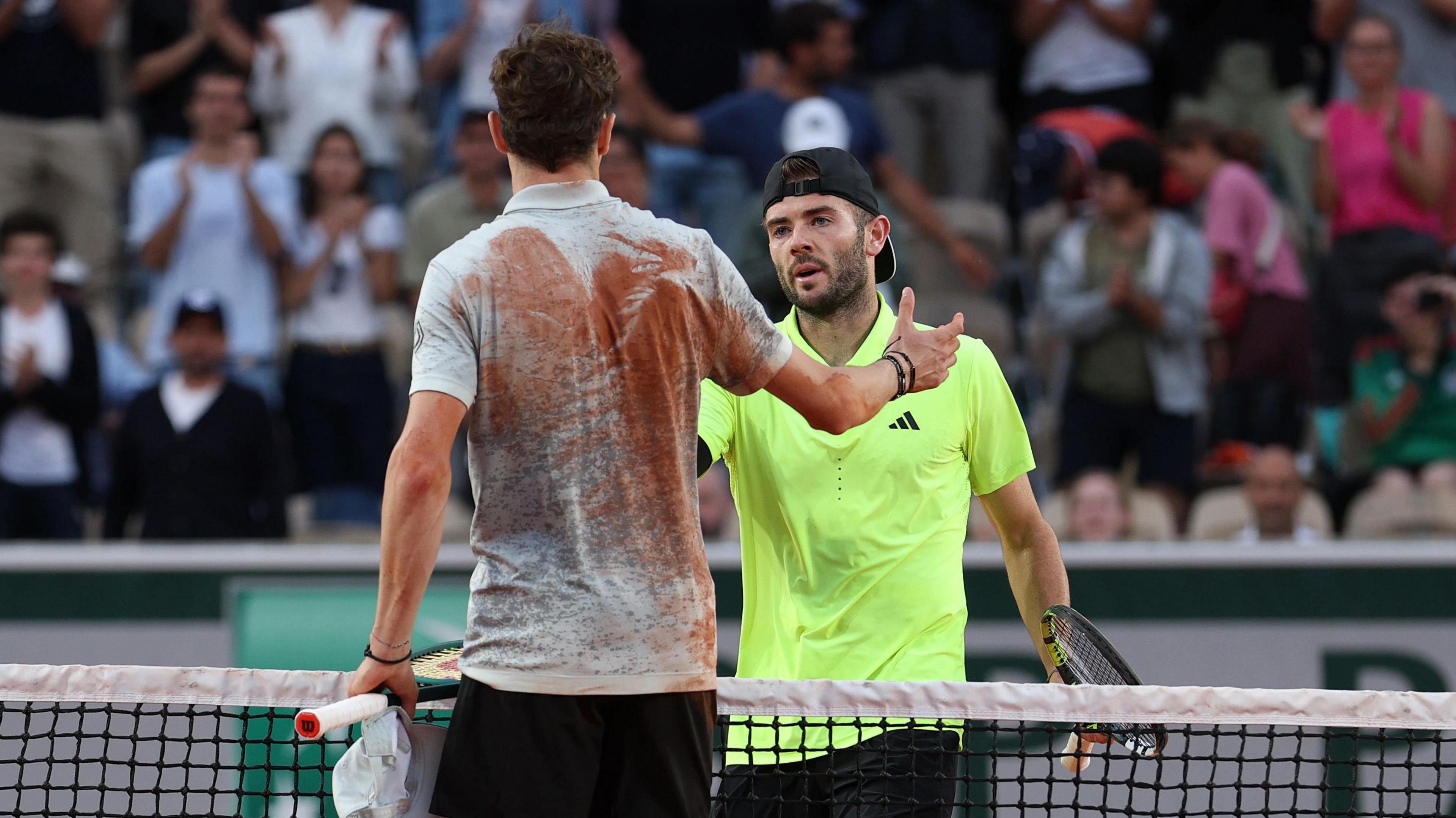 Jacob Fearnley shakes hands with Ugo Humbert