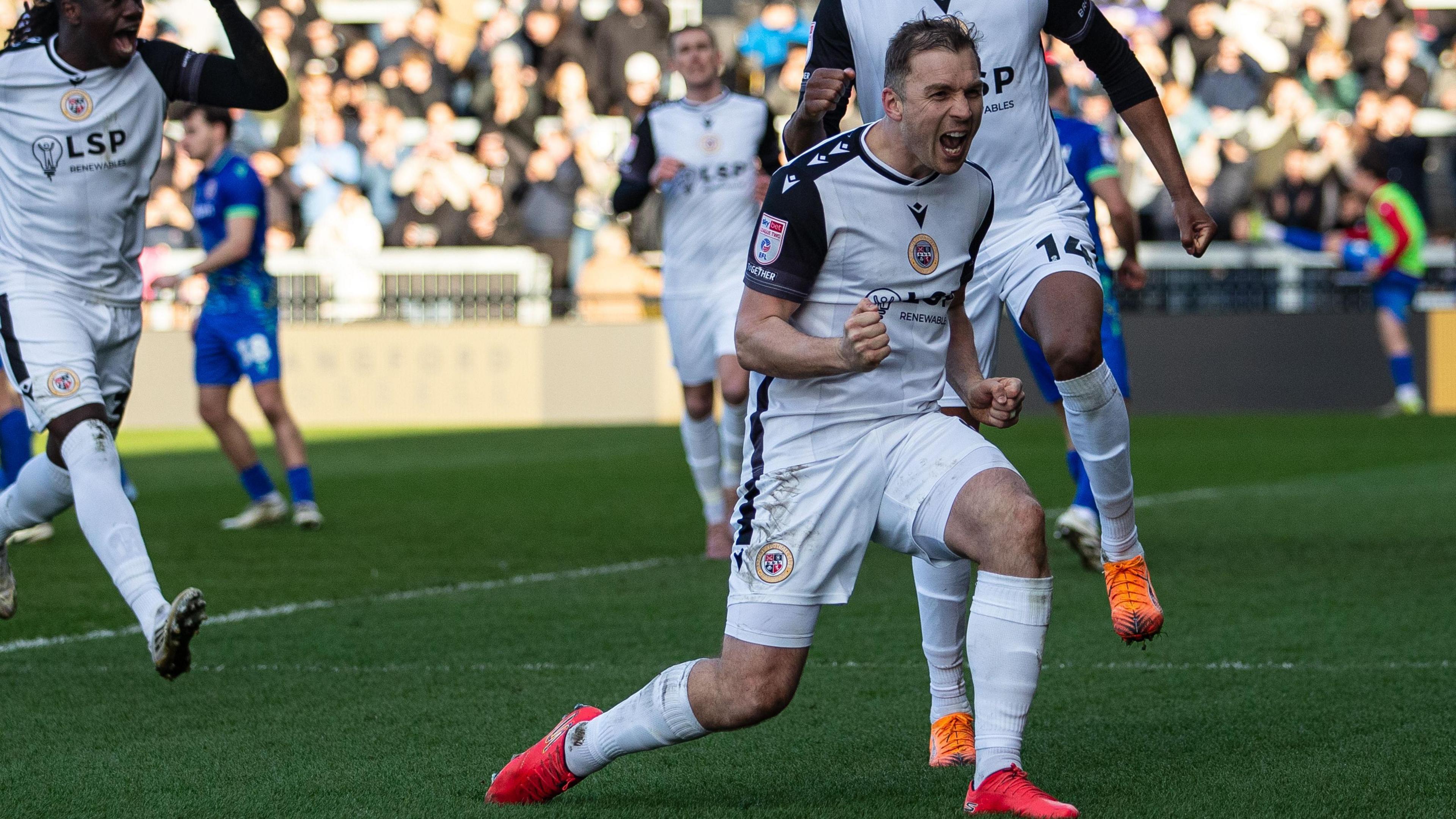 Michael Cheek celebrates scoring one of his 16 goals for Bromley to help earn them promotion to League One. 