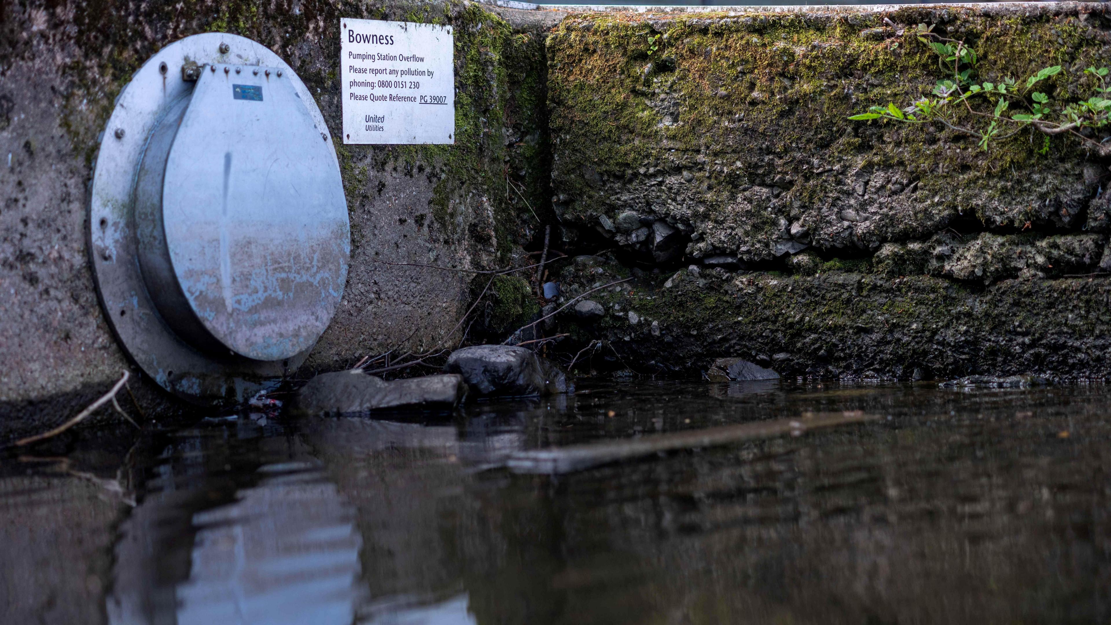 A United Utilities overflow pipe is seen near a jetty on the banks of Windermere, the largest lake in England