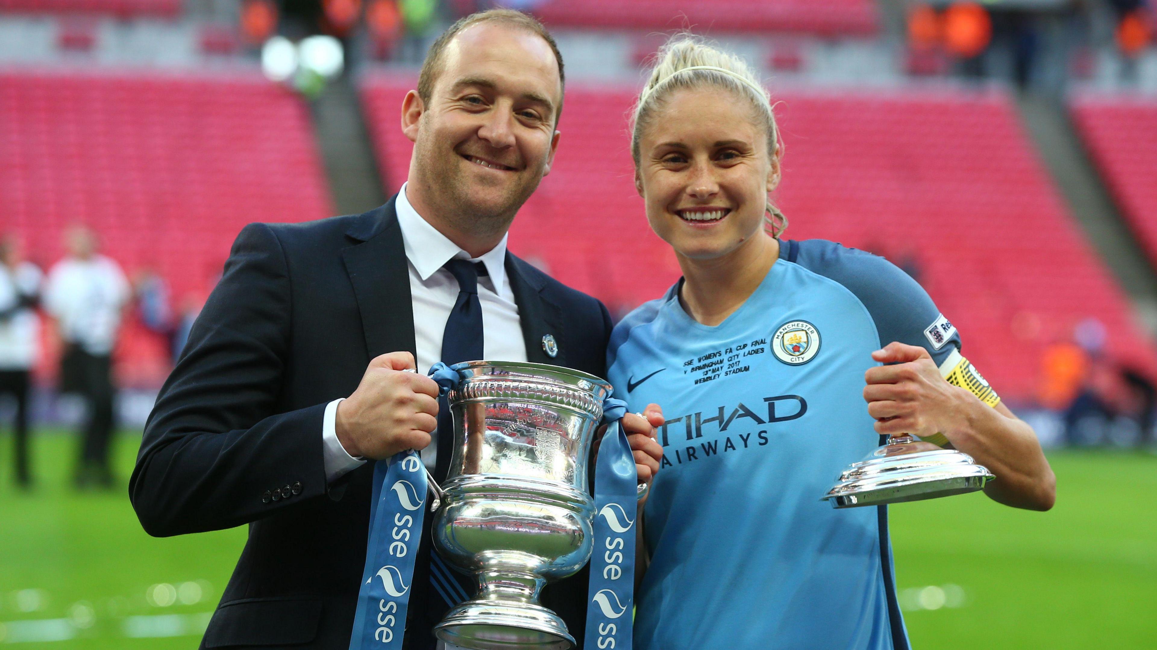 Cushing and Steph Houghton pose with the FA Cup trophy while with Manchester City