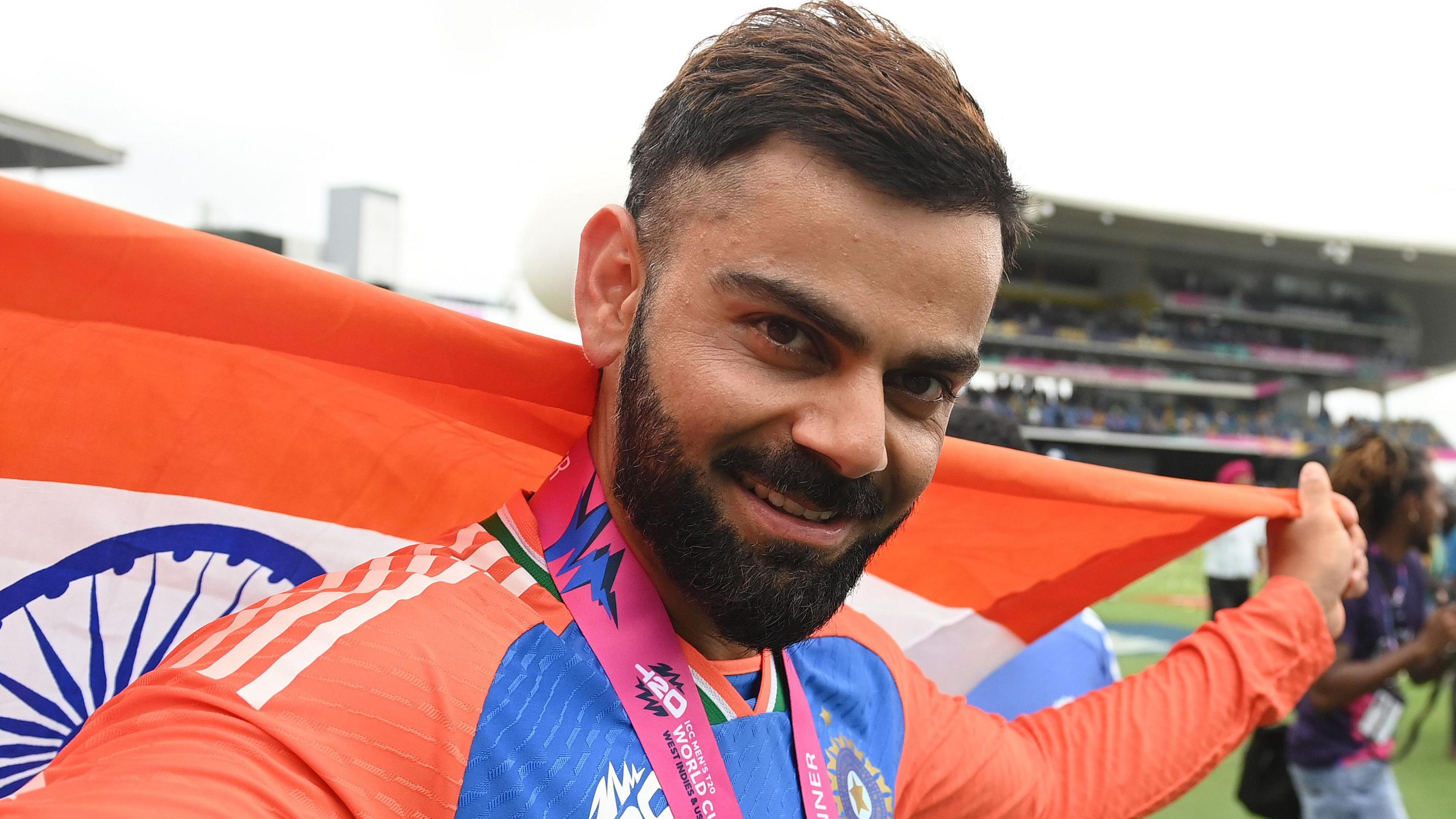 Virat Kohli celebrates with the flag of India after his side's T20 World Cup win in 2024