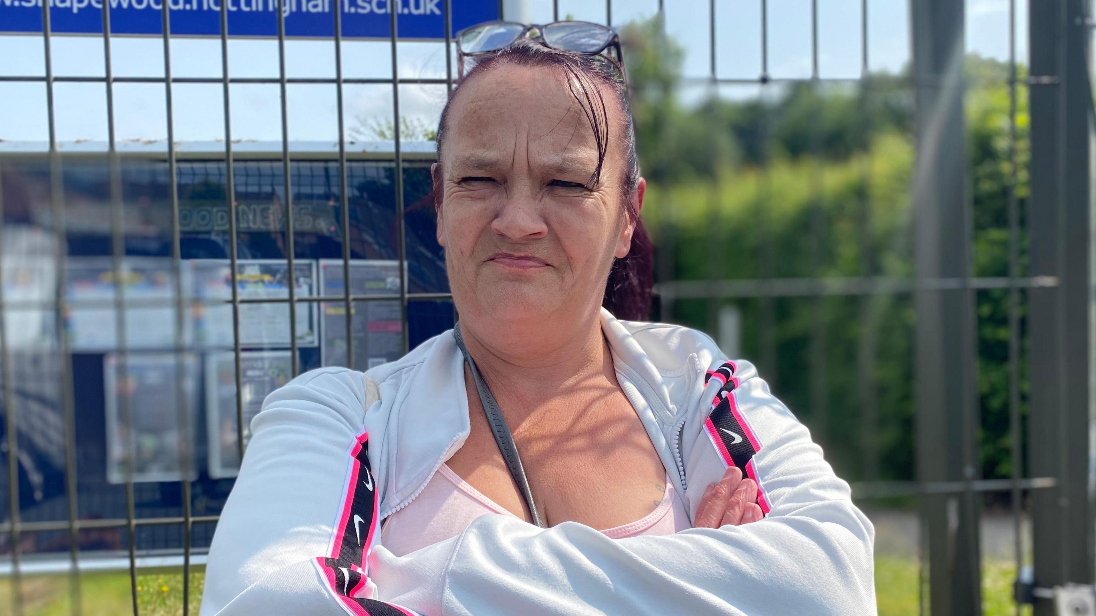 Sandra stood outside the school