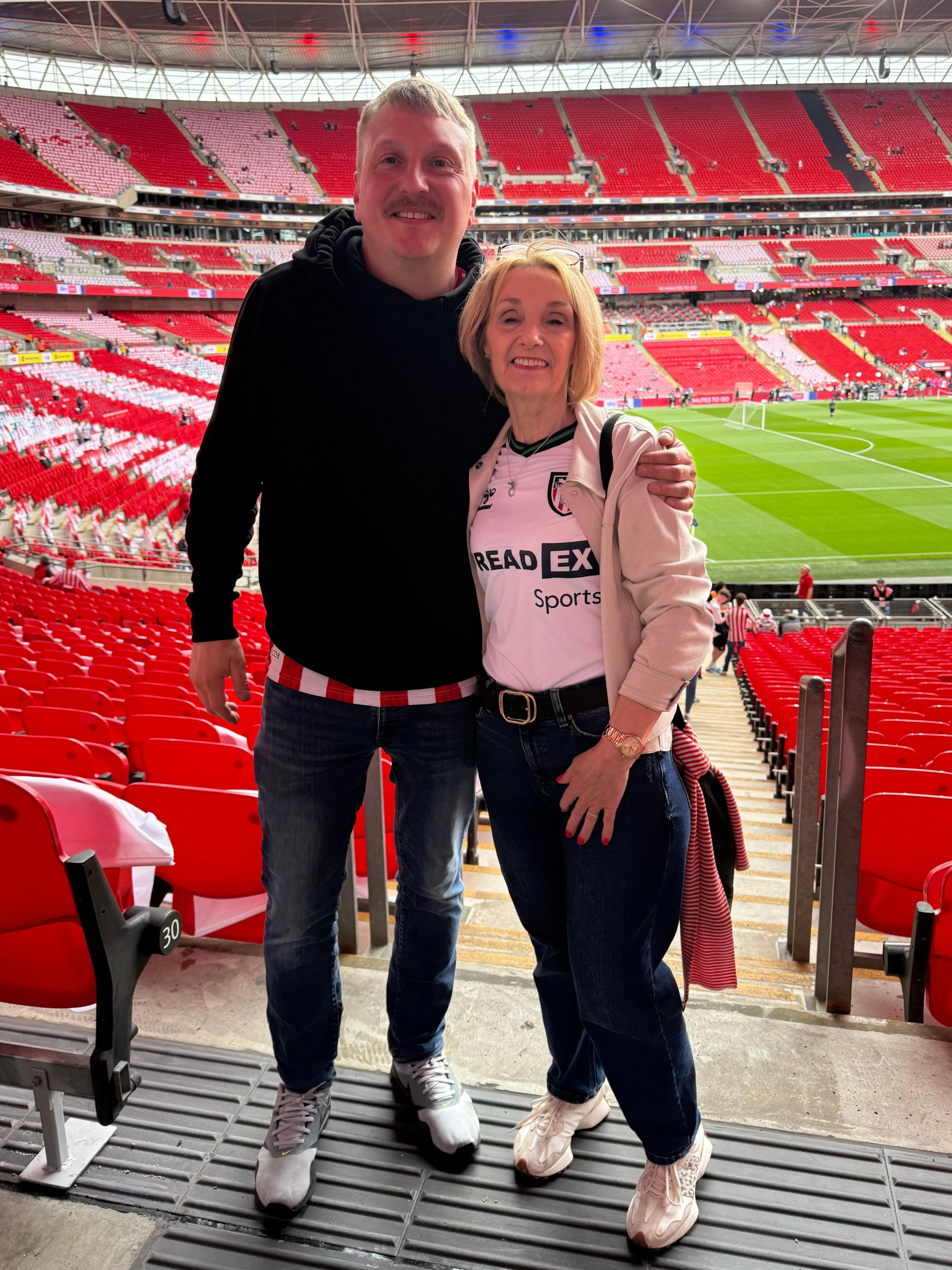 A son-in-law and mother-in-law stand together in stands at Stadium of Light