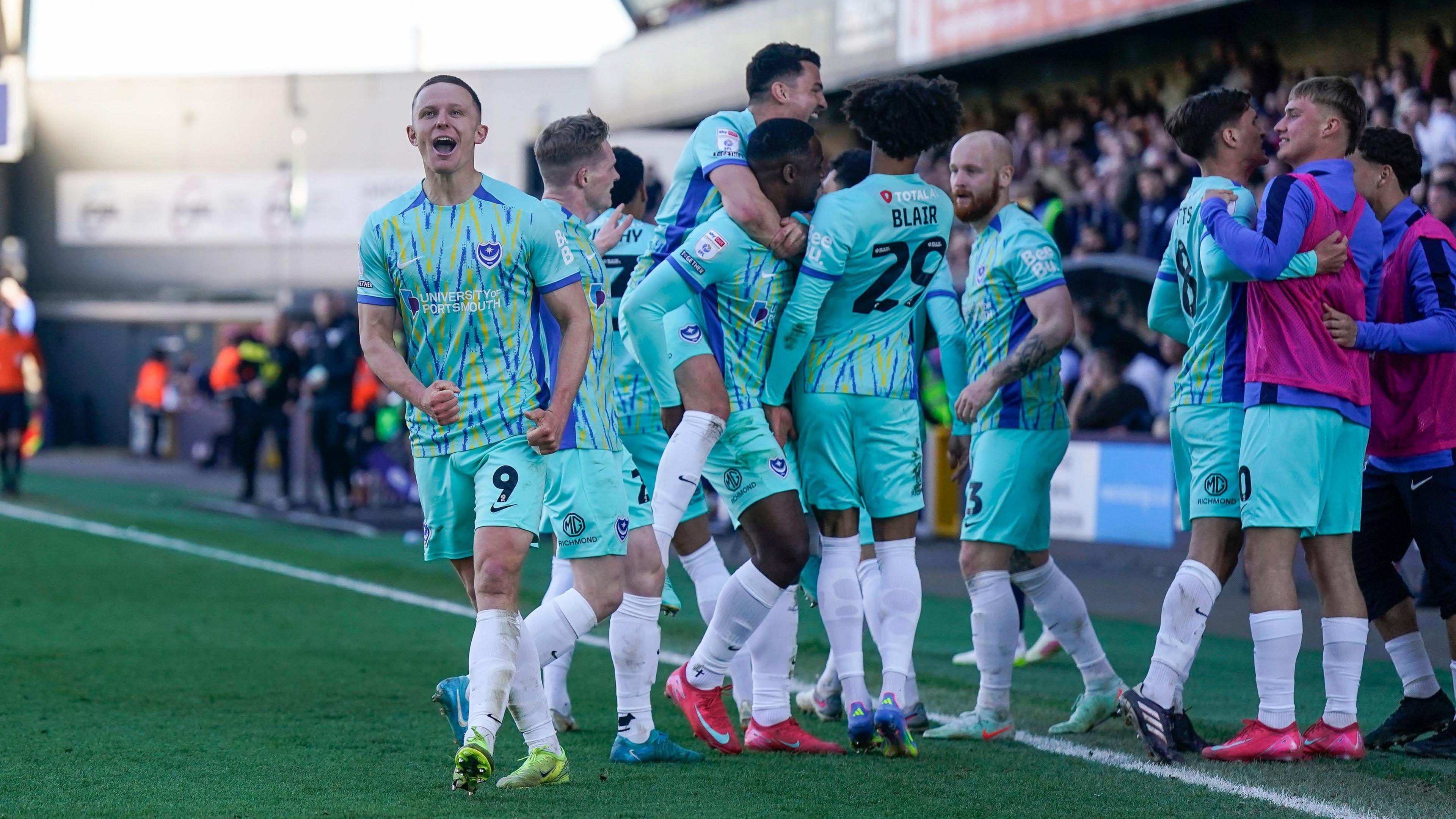 Colby Bishop and the Portsmouth players celebrate equalising against Millwall 