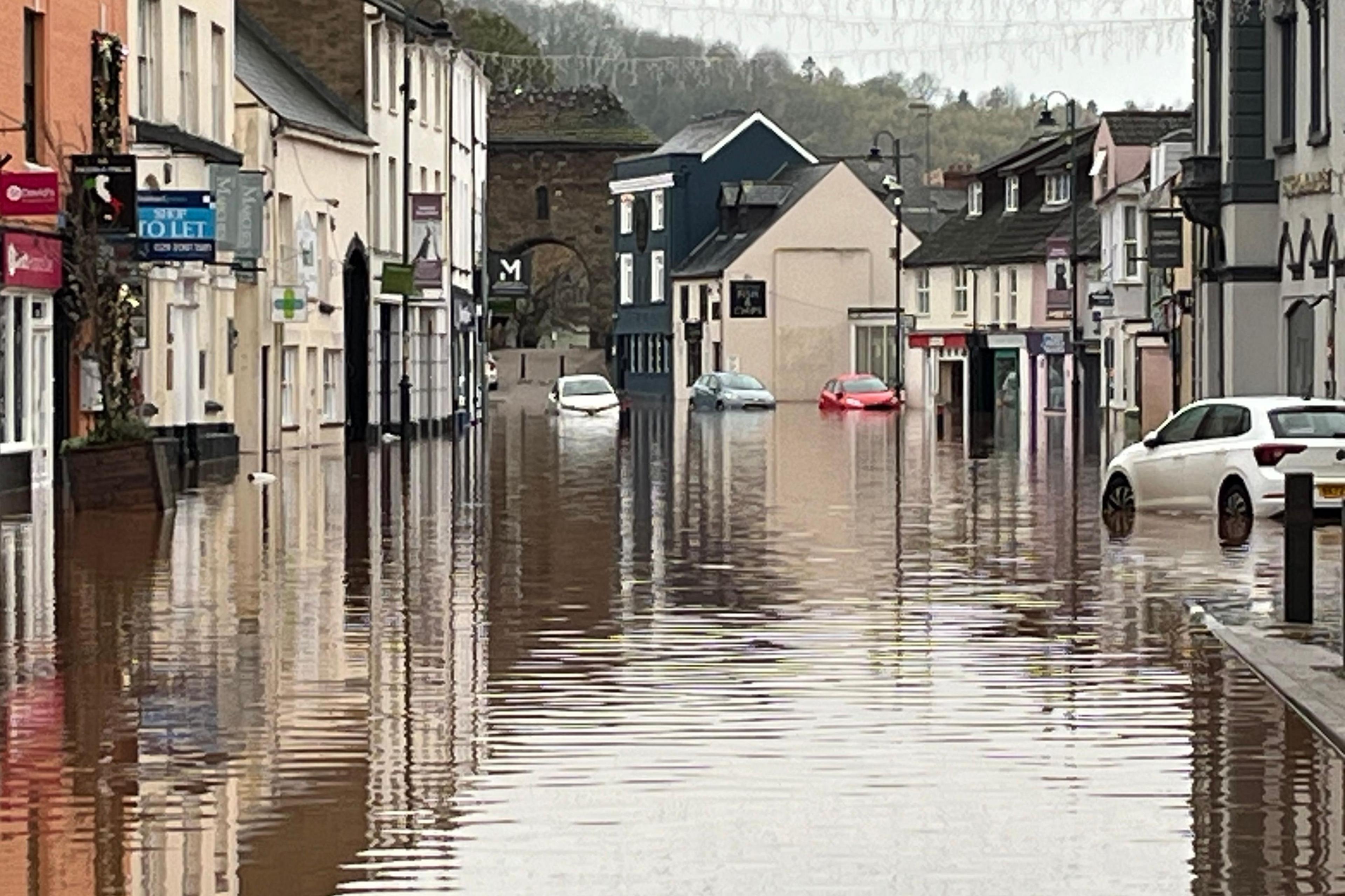 Flooding on a street in Monmouth with cars half submerged