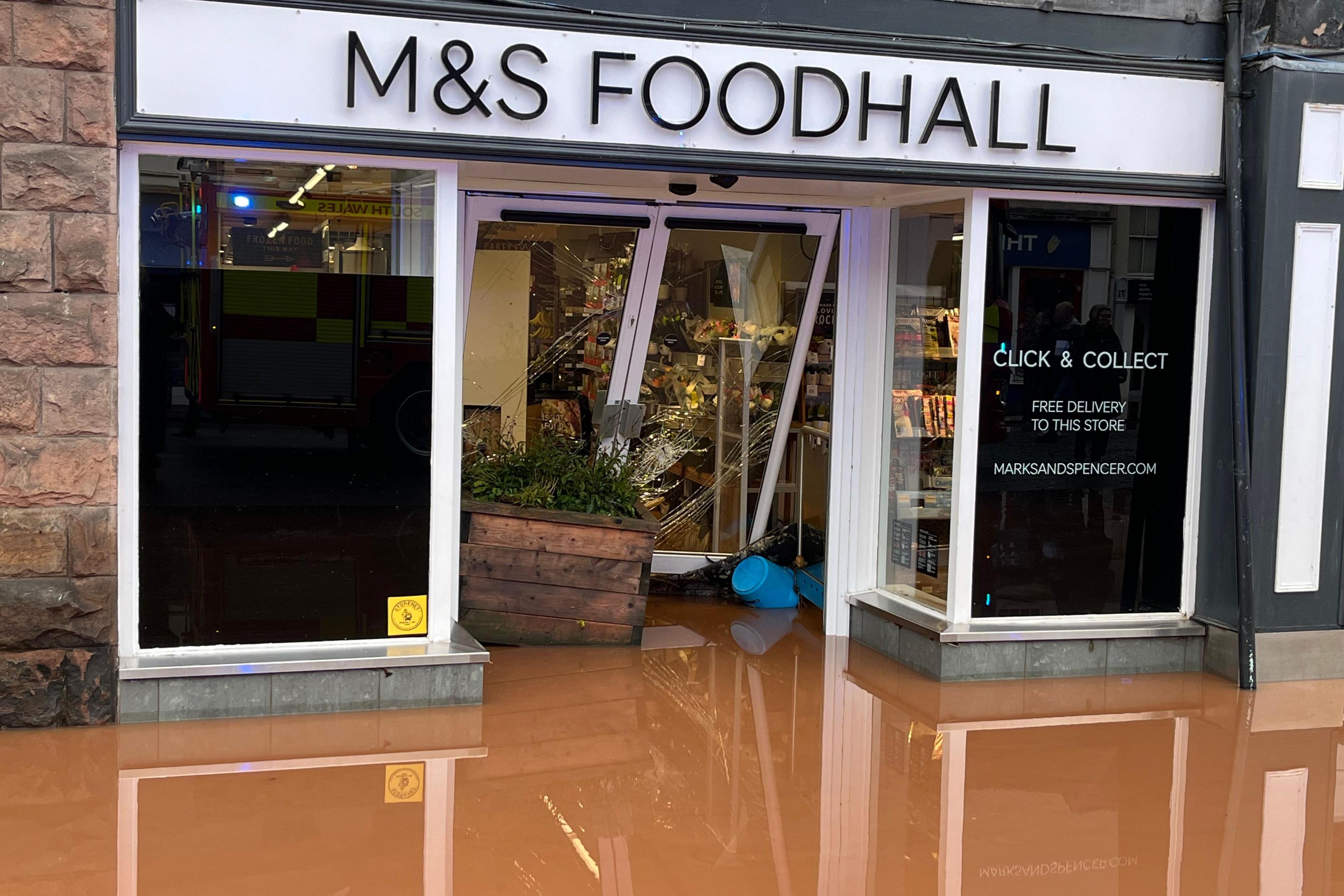 Floodwater rising infront of an M&S Foodhall