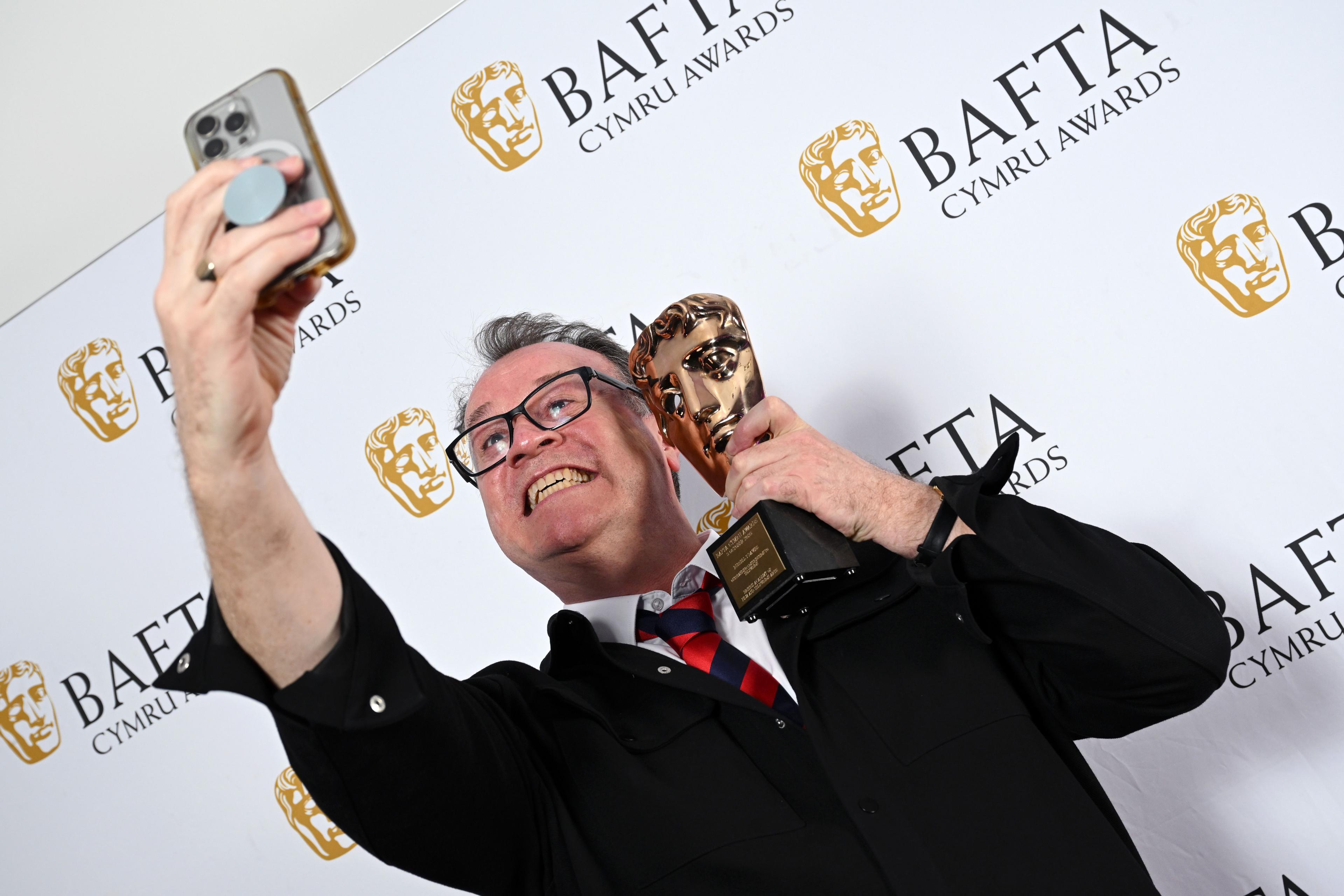 Russell T Davies poses with the Outstanding Contribution to Television Award in the Winners Room during the 2025 BAFTA Cymru Awards at the International Convention Centre Wales on October 05, 2025 in Newport, Wales.
