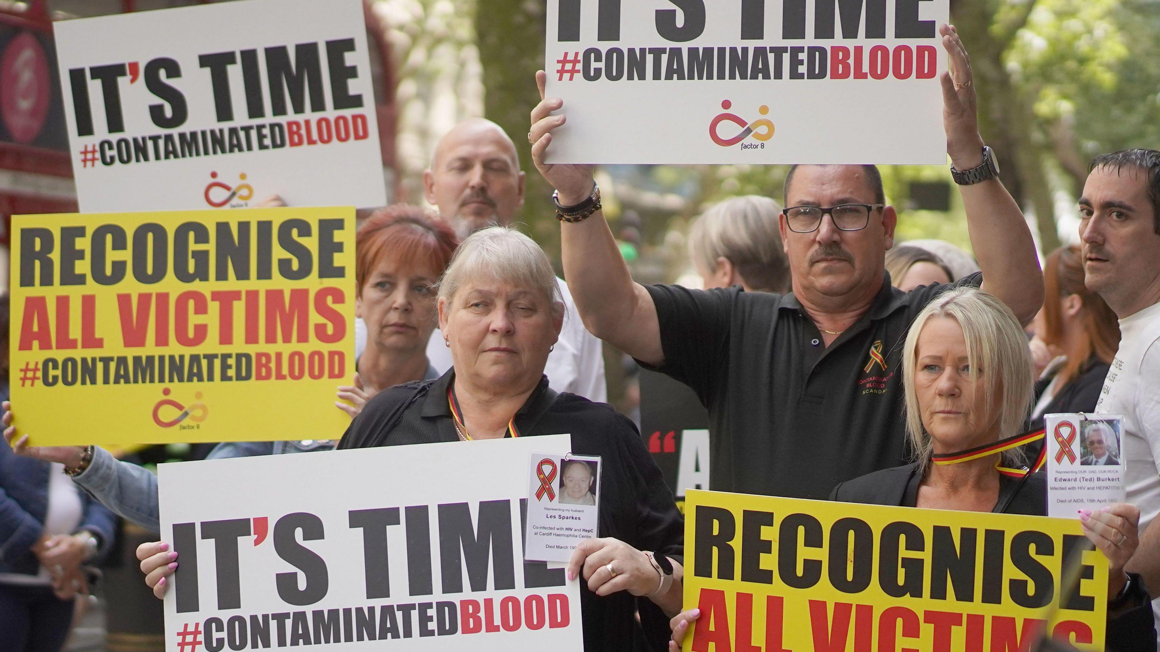 Image of protestors carrying signs about contaminated blood